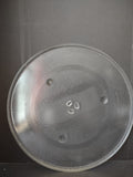 Vintage clear glass microwave turntable plate, front view showing textured surface and concentric rings