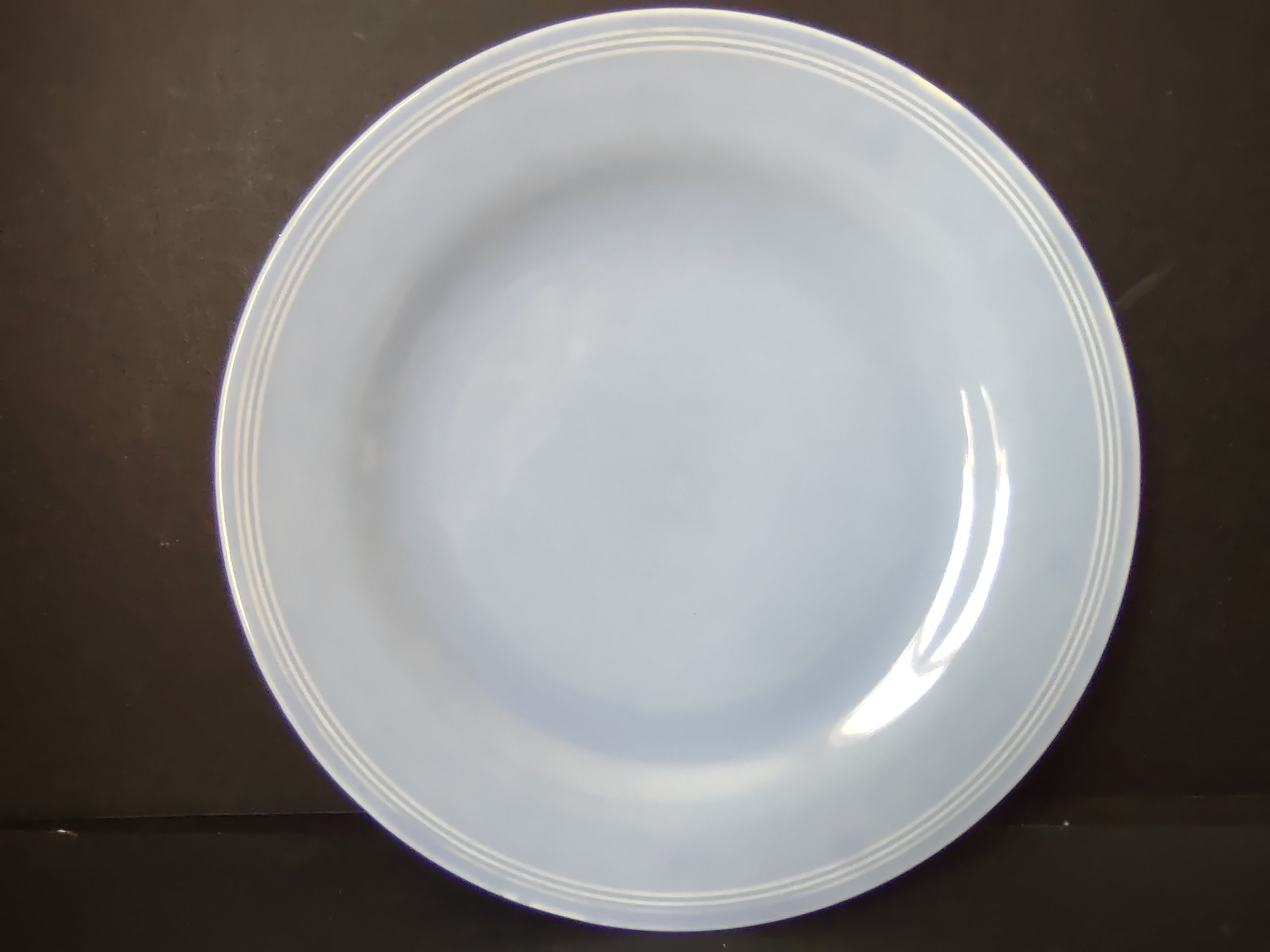 Vintage light blue plate front view showing embossed ring rim and clean well