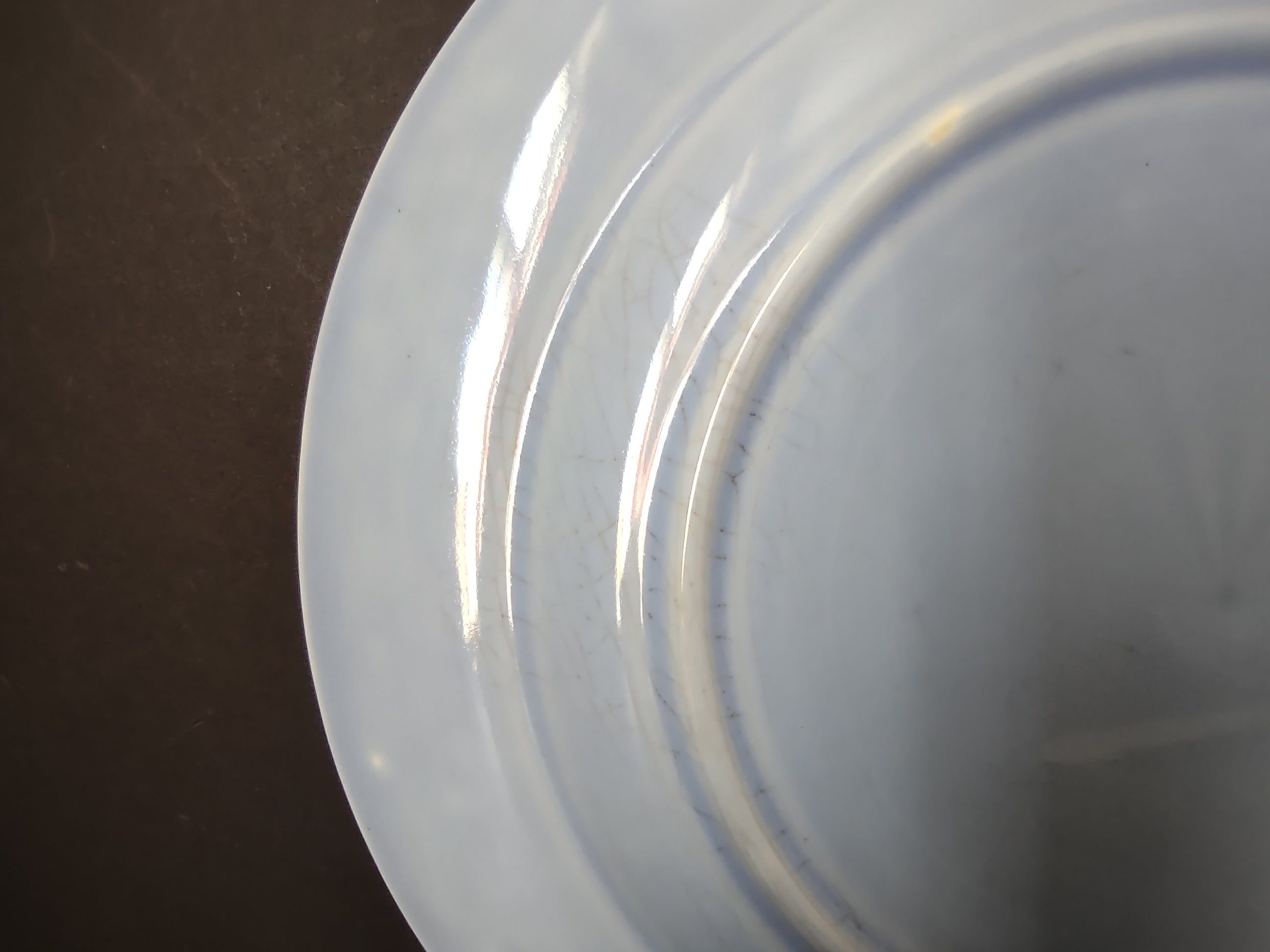 Vintage light blue plate close-up of concentric embossed rings on rim