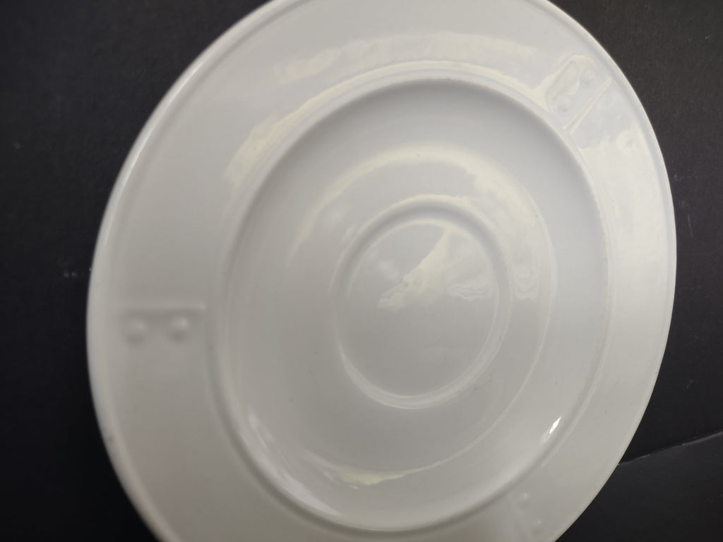 Metlox Poppytrail plain white saucer angled view showing glaze and form