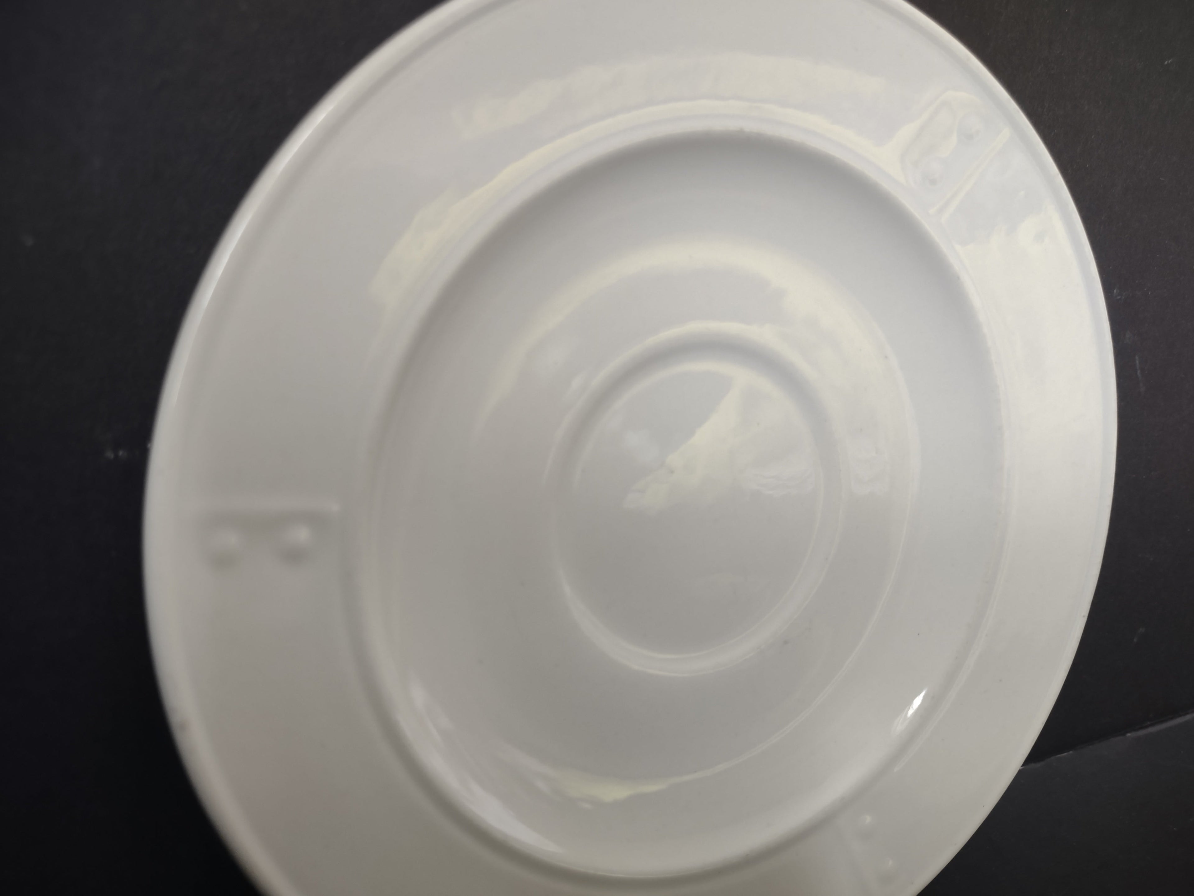 Metlox Poppytrail plain white saucer angled view showing glaze and form
