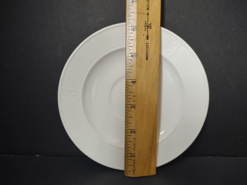 Metlox Poppytrail plain white saucer with ruler showing approximately 6 inch diameter