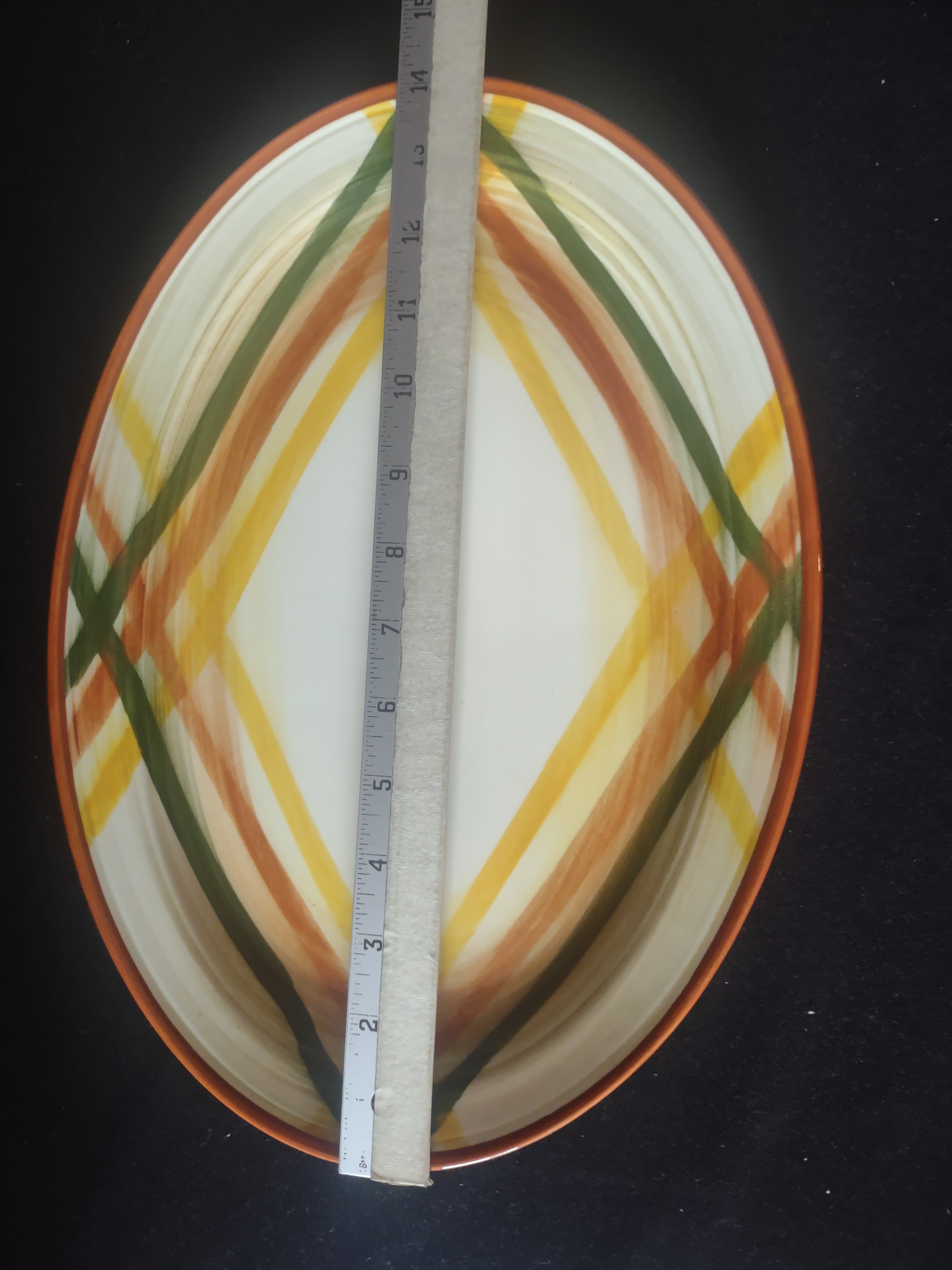 Close-up of diamond plaid center pattern in rust, yellow, and green