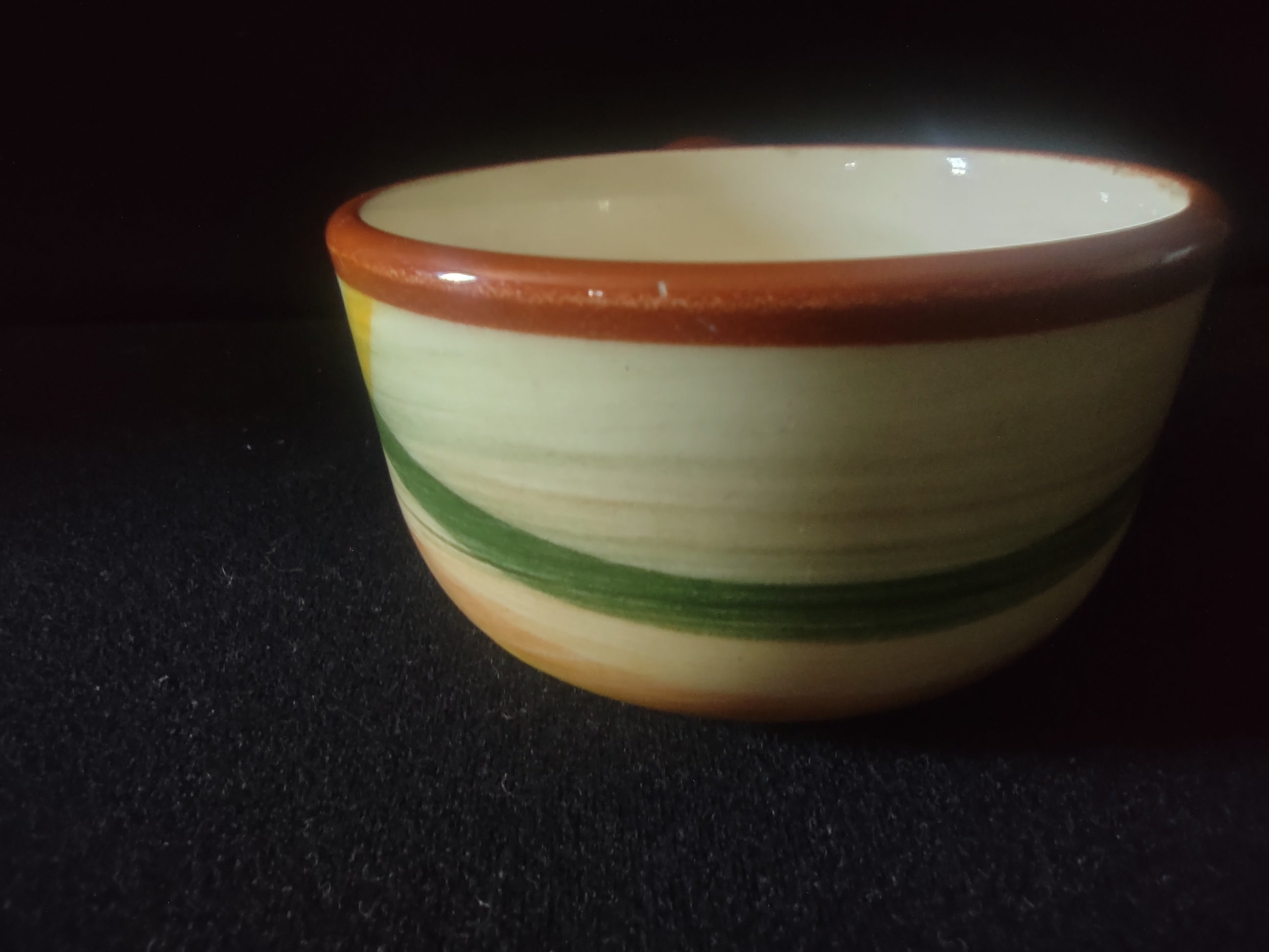 Vernonware Homespun handled soup bowl - side view showing orange green yellow crosshatch pattern and handle