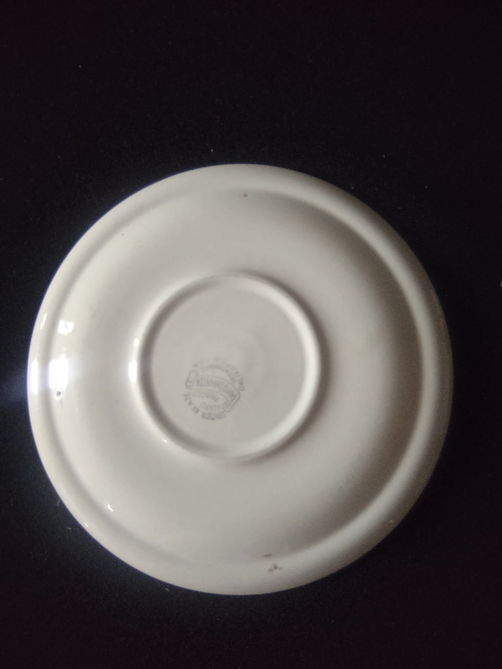 Vernon Kilns Tam O'Shanter saucer full view showing green orange plaid pattern on off-white ground