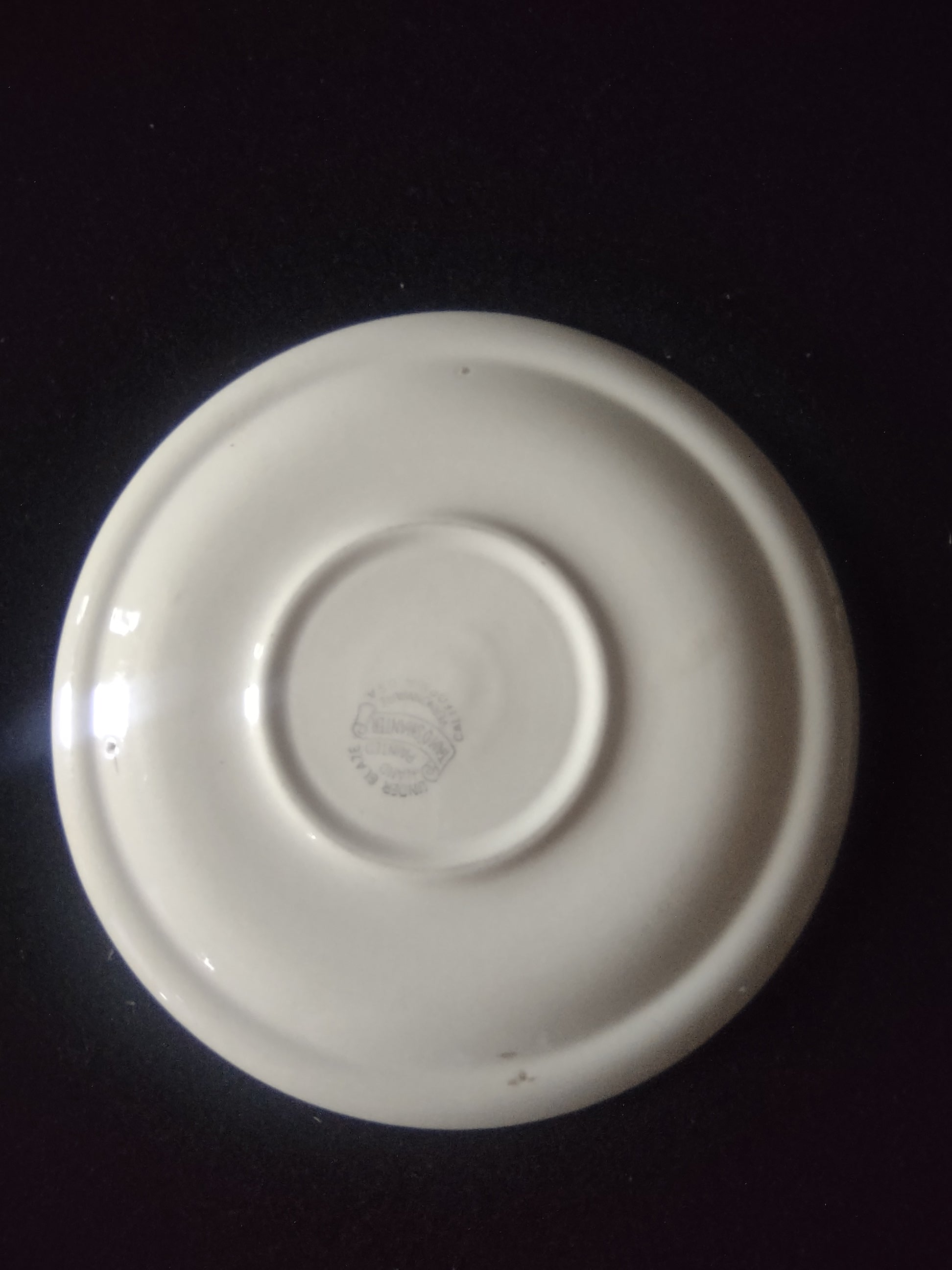 Vernon Kilns Tam O'Shanter saucer full view showing green orange plaid pattern on off-white ground