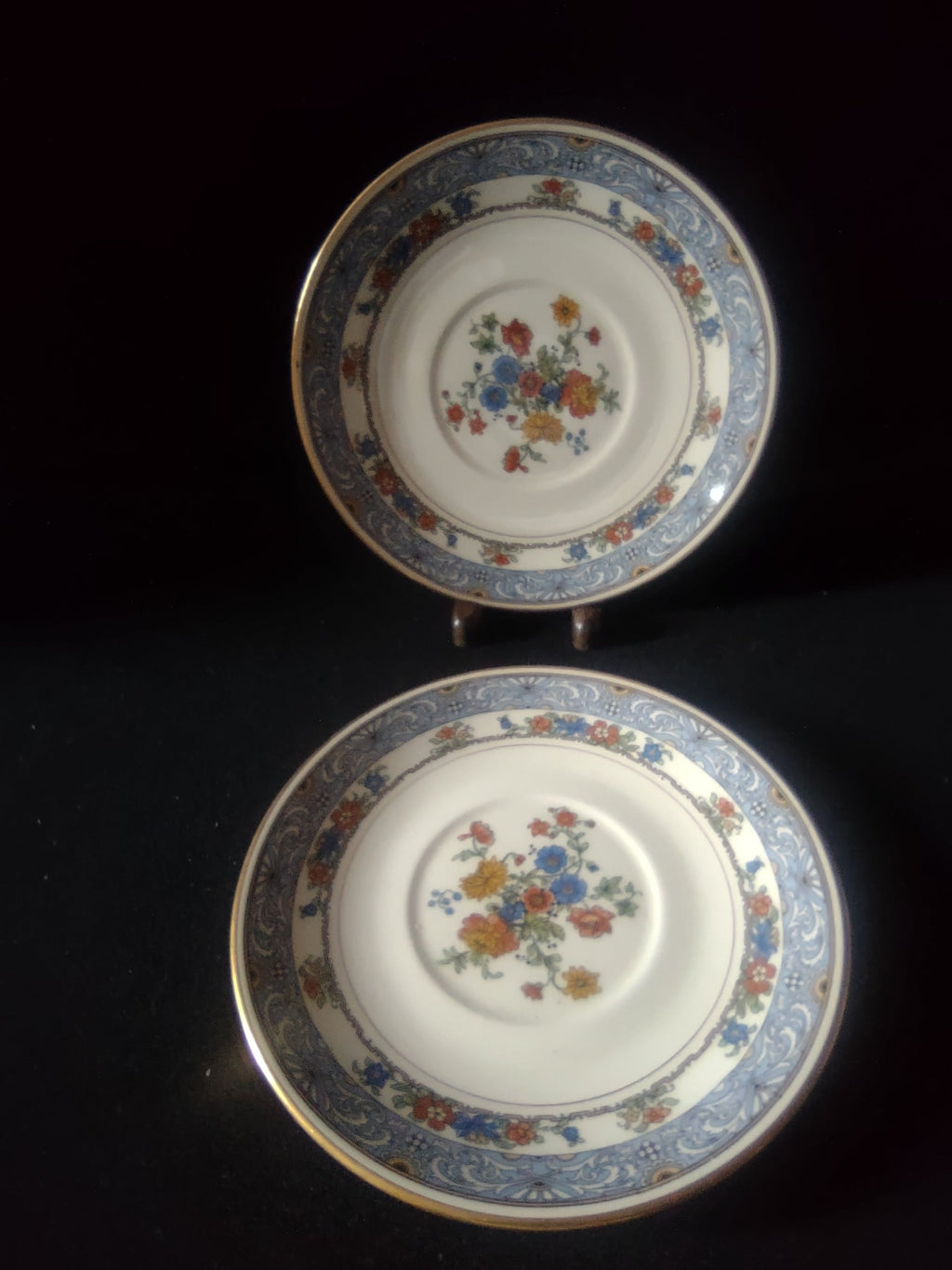 Coxon Belleek Boulevard saucer close-up of orange and blue floral center bouquet