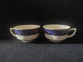 Vintage O.P.Co. Syracuse China W-12 cobalt blue gold teacup set of 2, front view showing both cups