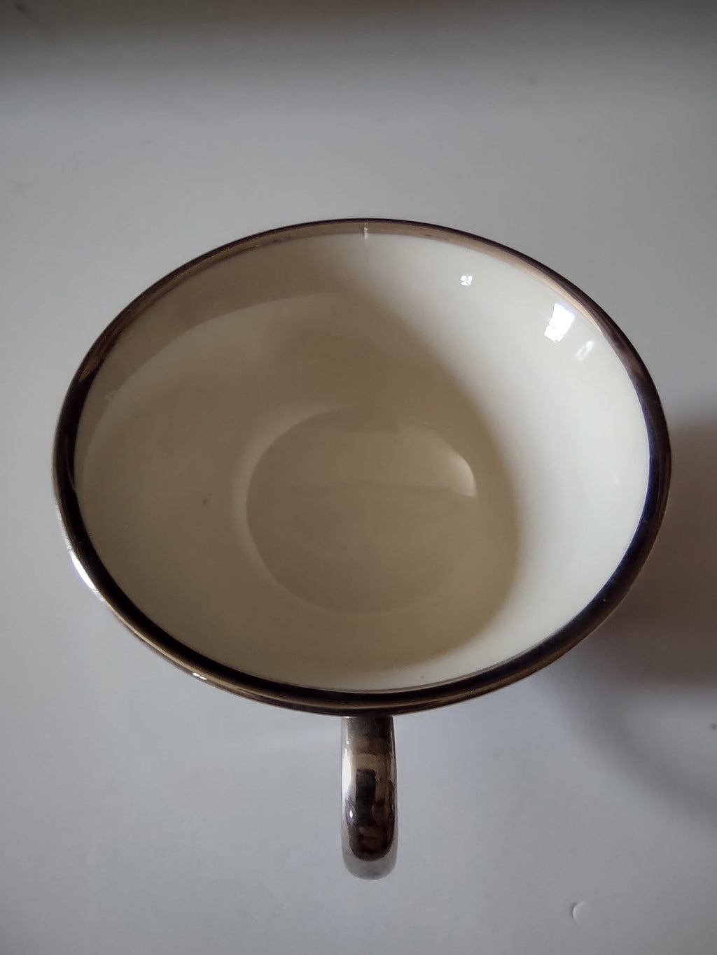 Flintridge China teal footed cup interior view showing off-white glaze and platinum rim