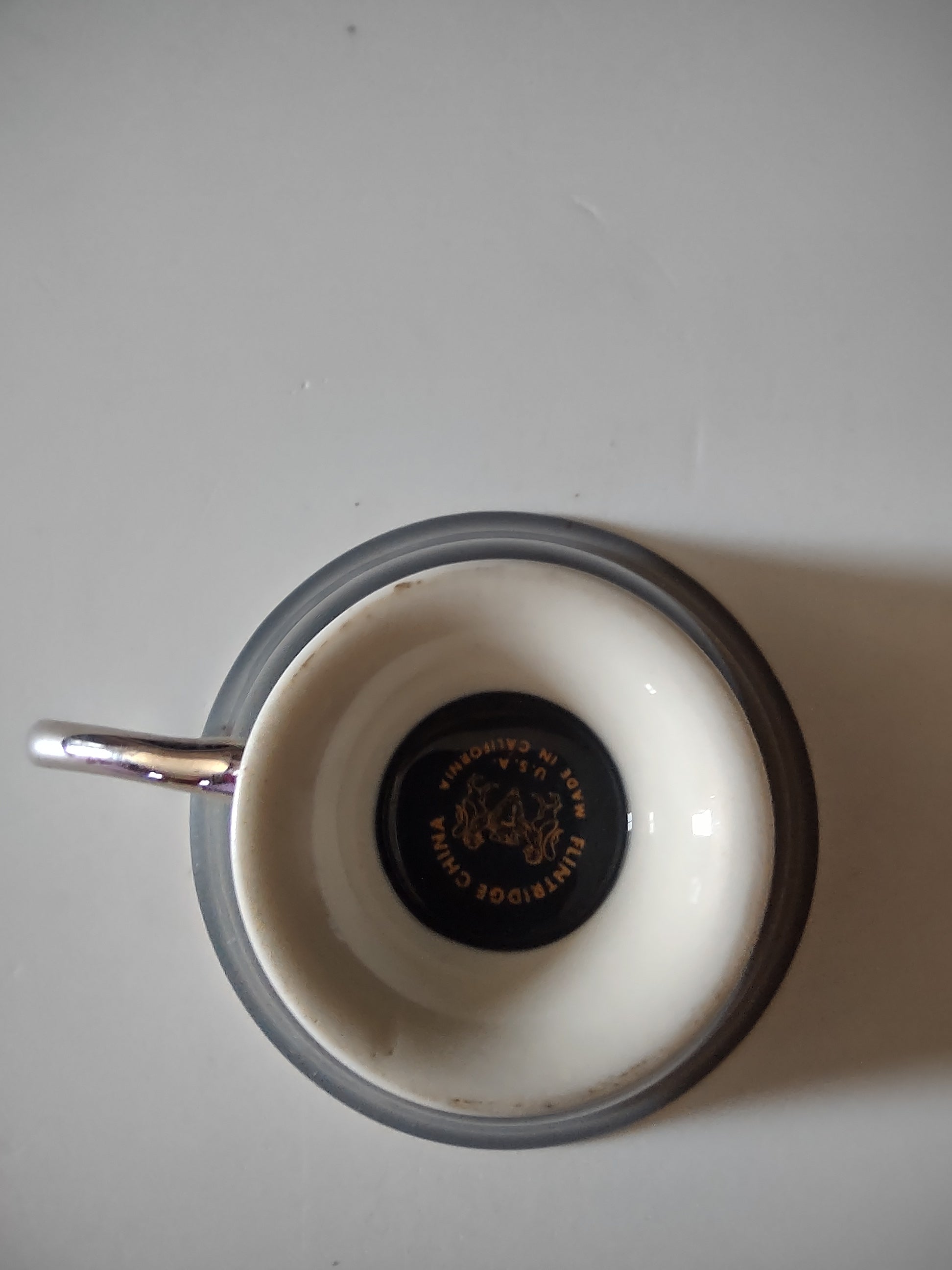 Flintridge China teal footed cup base detail showing polished platinum pedestal foot