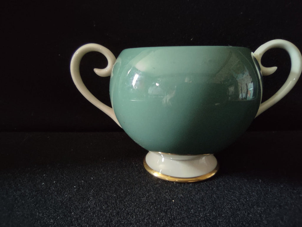Vintage Flintridge China teal open sugar bowl with ruler showing approximately 4 inches tall - side view with scroll handles and gold trim foot
