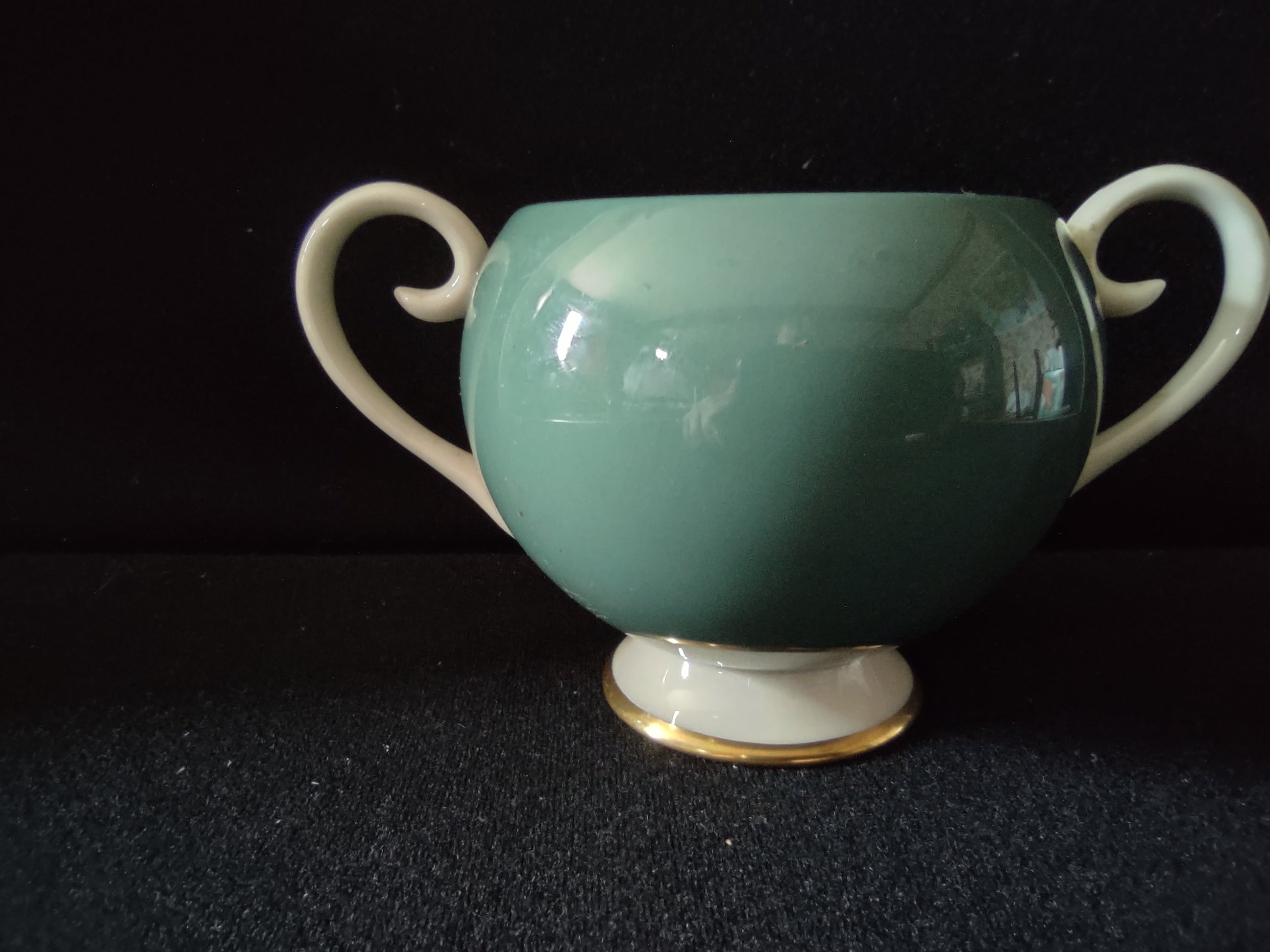 Vintage Flintridge China teal open sugar bowl with ruler showing approximately 4 inches tall - side view with scroll handles and gold trim foot