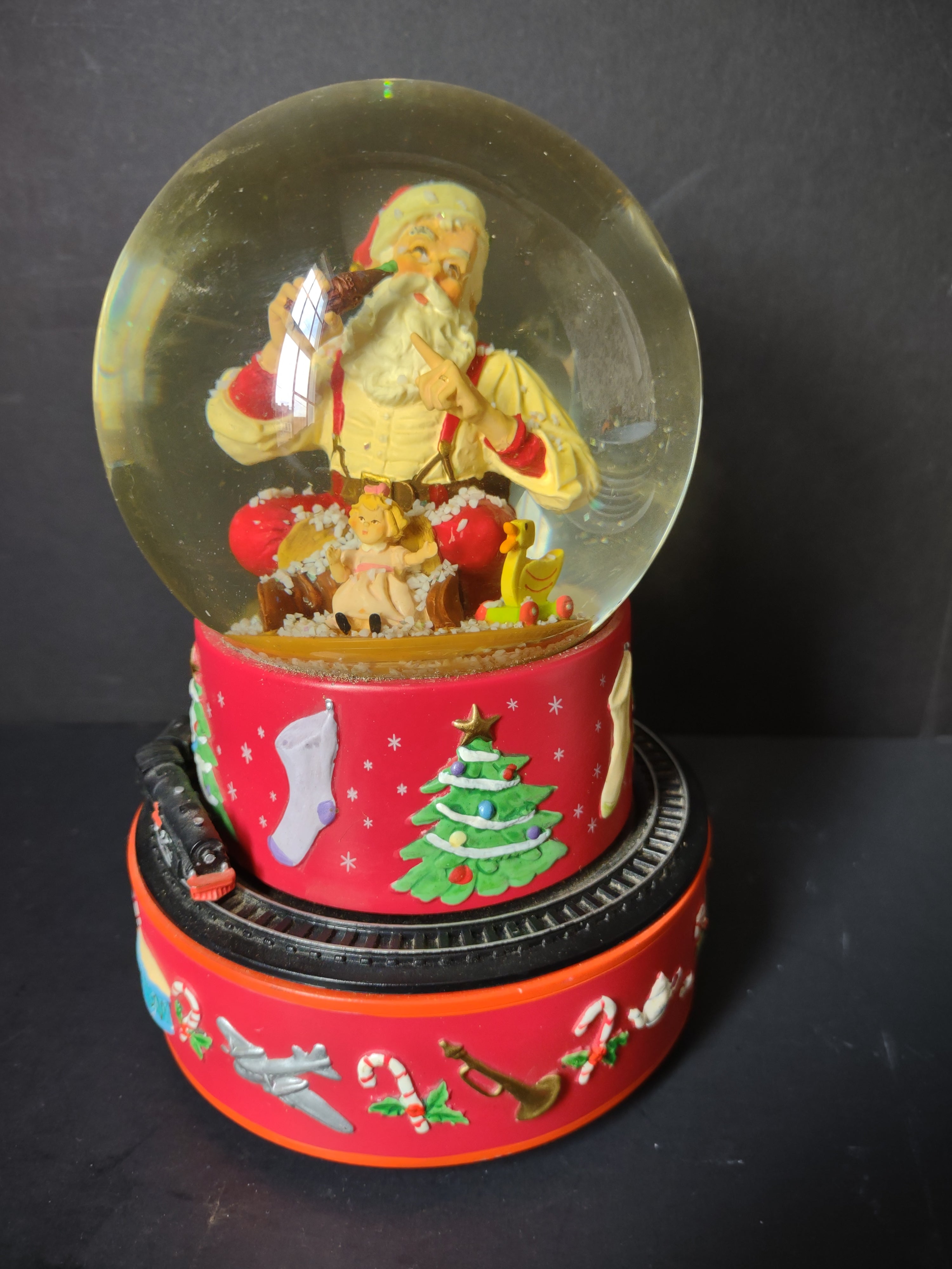 Vintage Coca-Cola Hallmark musical snow globe side view showing Santa with children inside globe and train on track