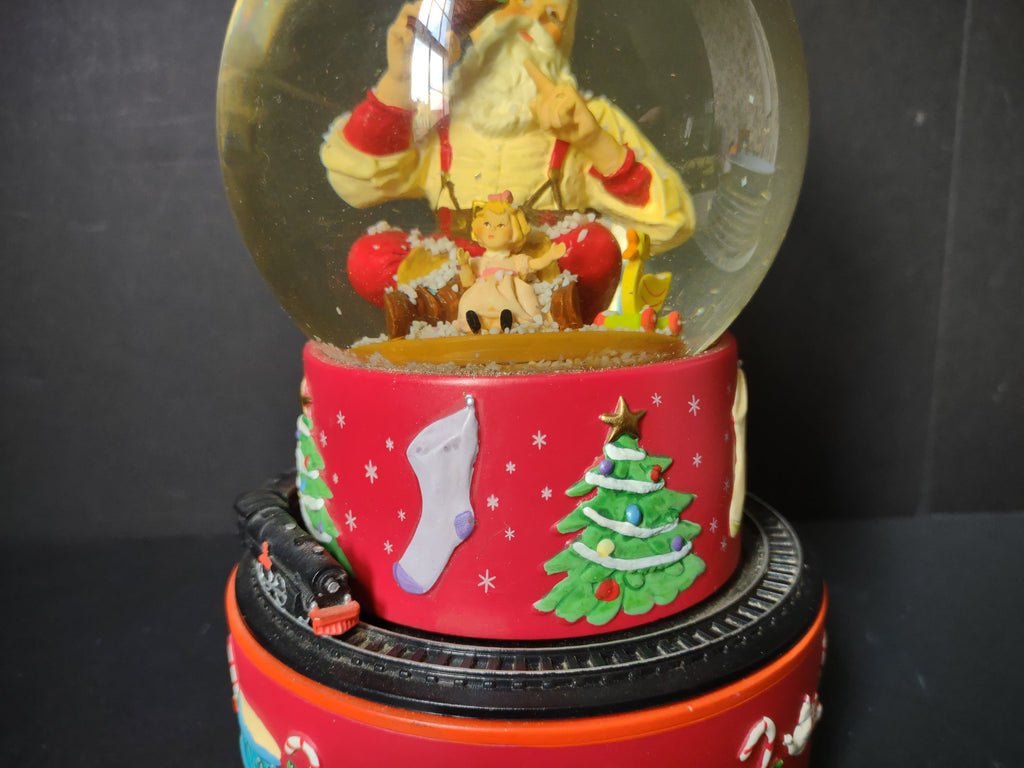 Vintage Coca-Cola Hallmark musical snow globe full view with snow swirling inside globe showing Santa Claus figure