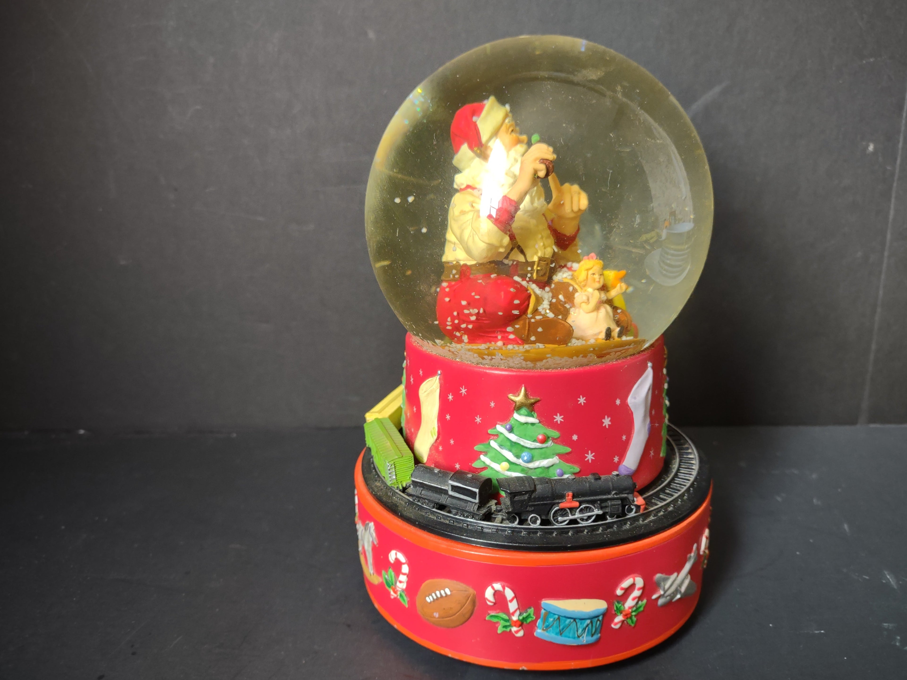 Vintage Coca-Cola Hallmark musical snow globe side view showing train cars circling the base