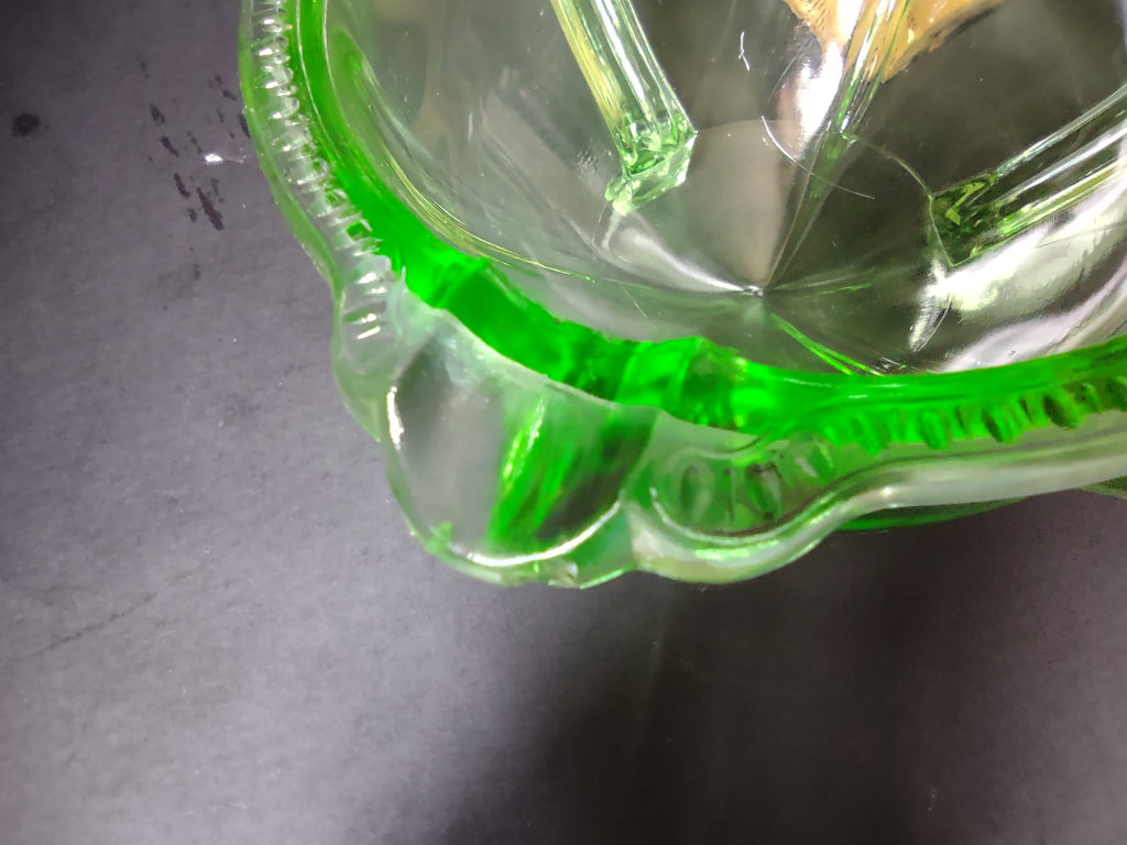 Vintage green uranium glass footed bowl top view showing scalloped rim and tulip bud interior ribs