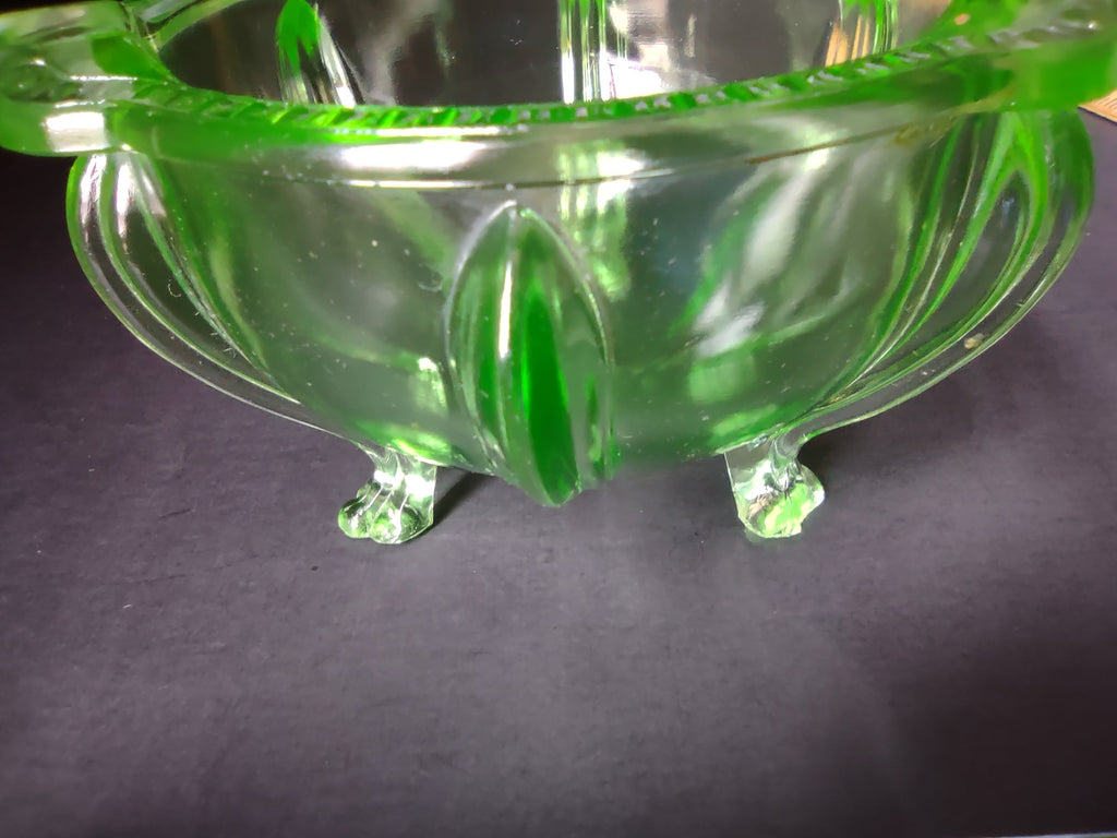 Vintage green uranium glass footed bowl side view showing tulip feet and vertical ribbing