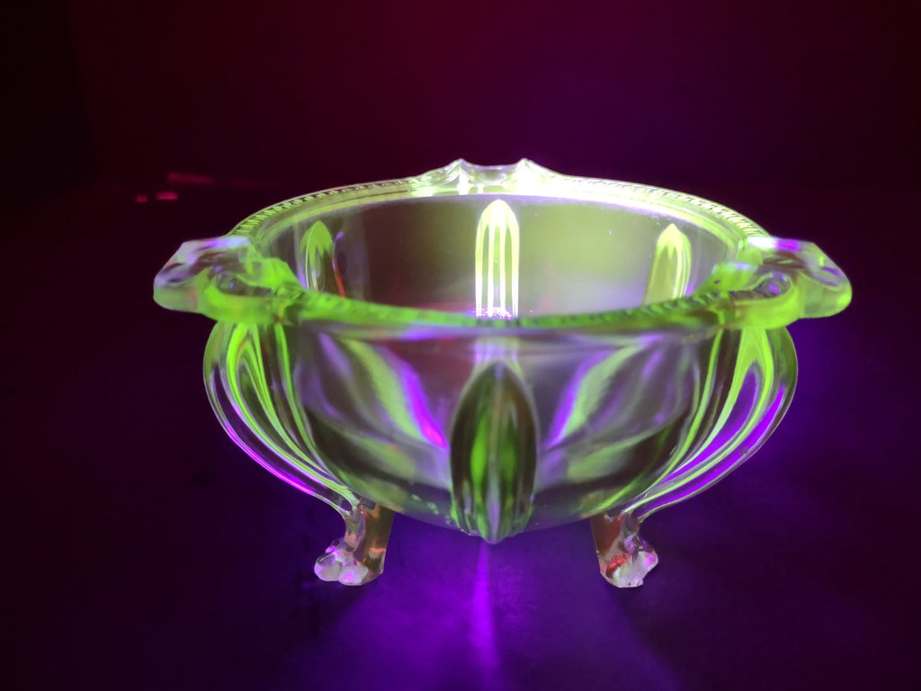 Vintage green uranium glass footed bowl close-up of foot showing chip damage