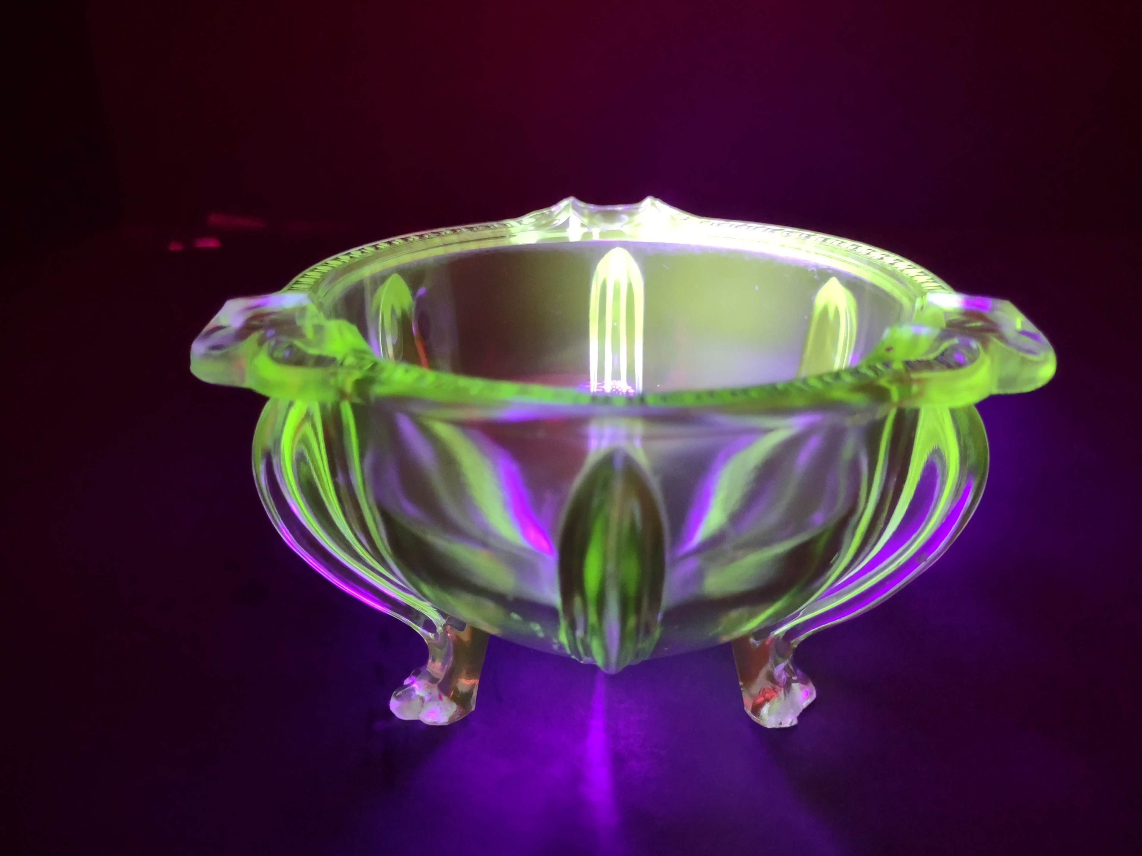 Vintage green uranium glass footed bowl close-up of foot showing chip damage