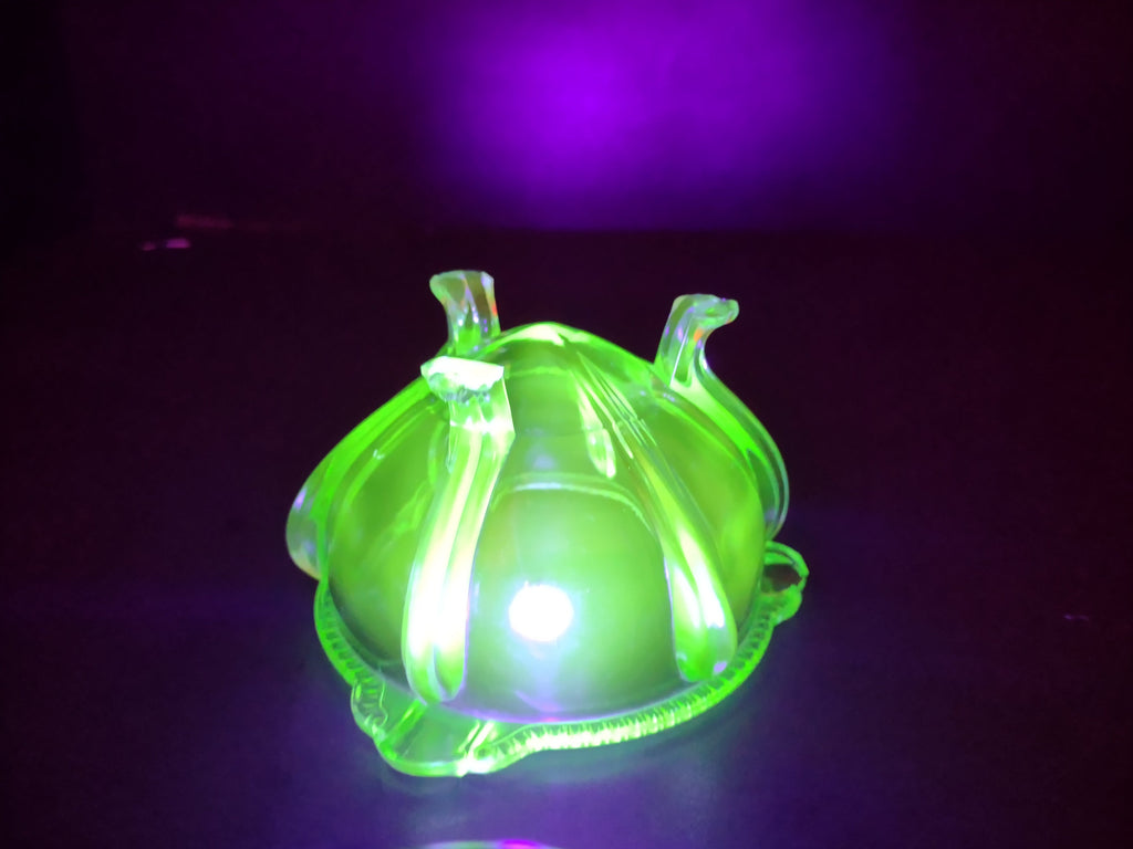 Vintage green uranium glass footed bowl with ruler showing approximately 5 inch diameter