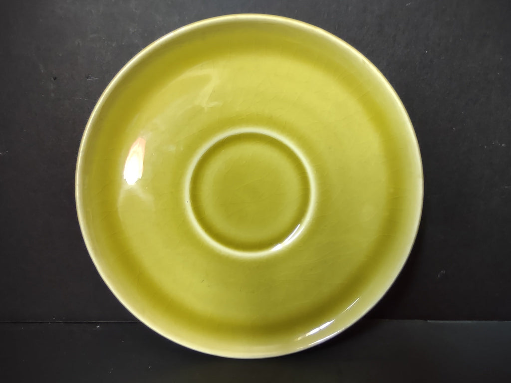 Vintage Russel Wright American Modern chartreuse saucer front view showing vibrant yellow-green glaze