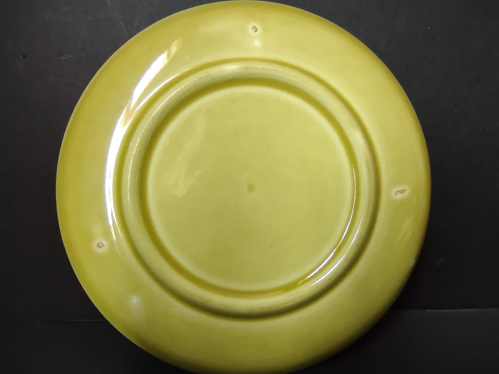Vintage Russel Wright American Modern chartreuse saucer back view showing foot ring and glaze