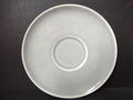 Vintage white unbranded saucer back view showing plain off-white glaze and concentric rings