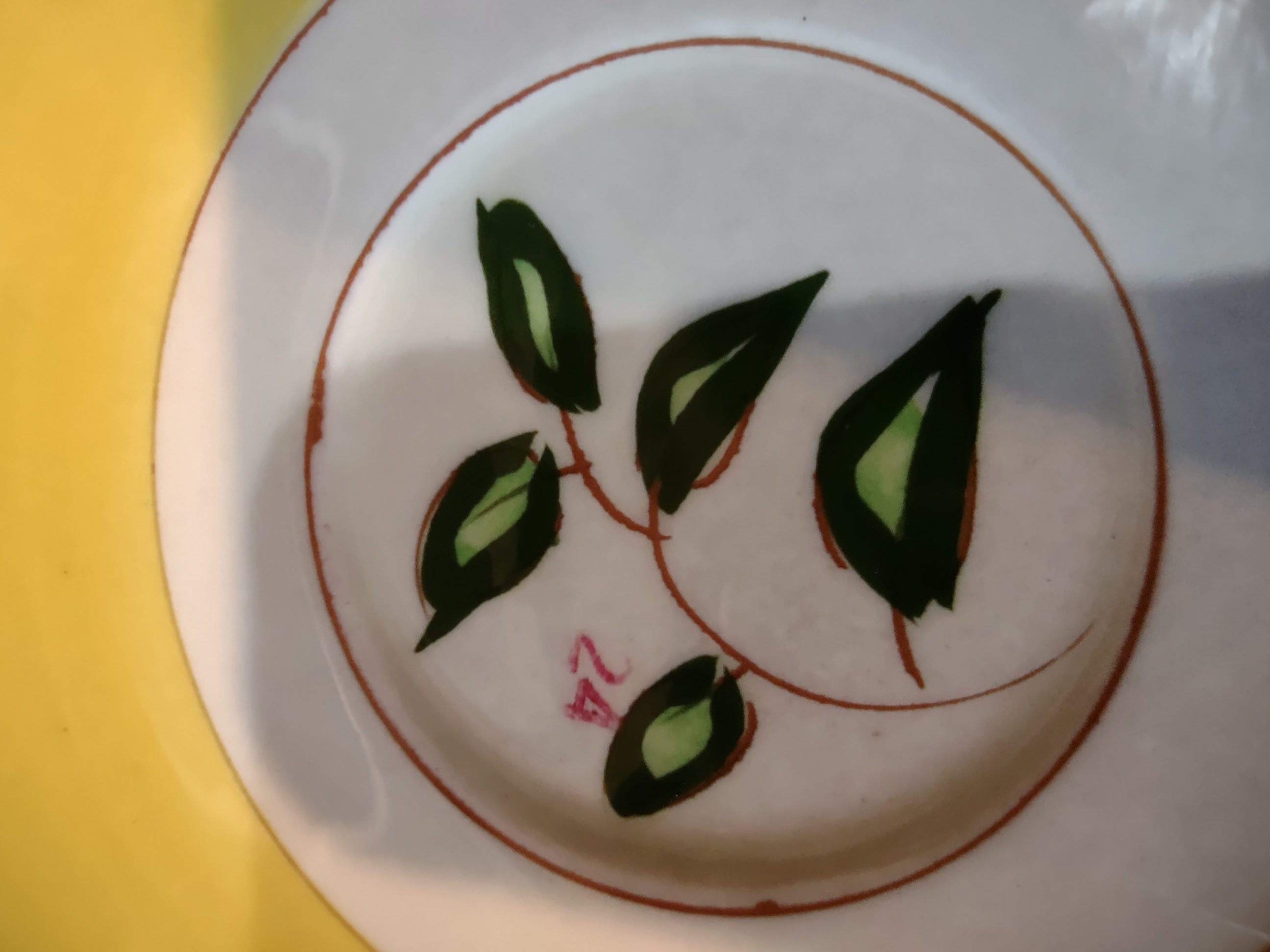 Vintage Stangl Pottery Blueberry Yellow Saucer - close-up of hand-painted blueberry leaf and bud motif in well