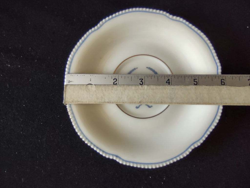 Side view of cup showing blue laurel wreath and gold foot ring