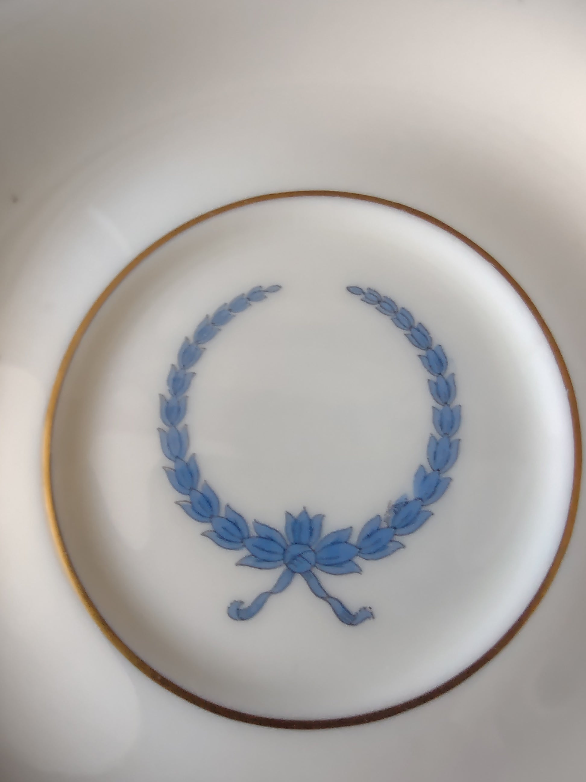 Top view of cup interior showing blue line border and gold rim