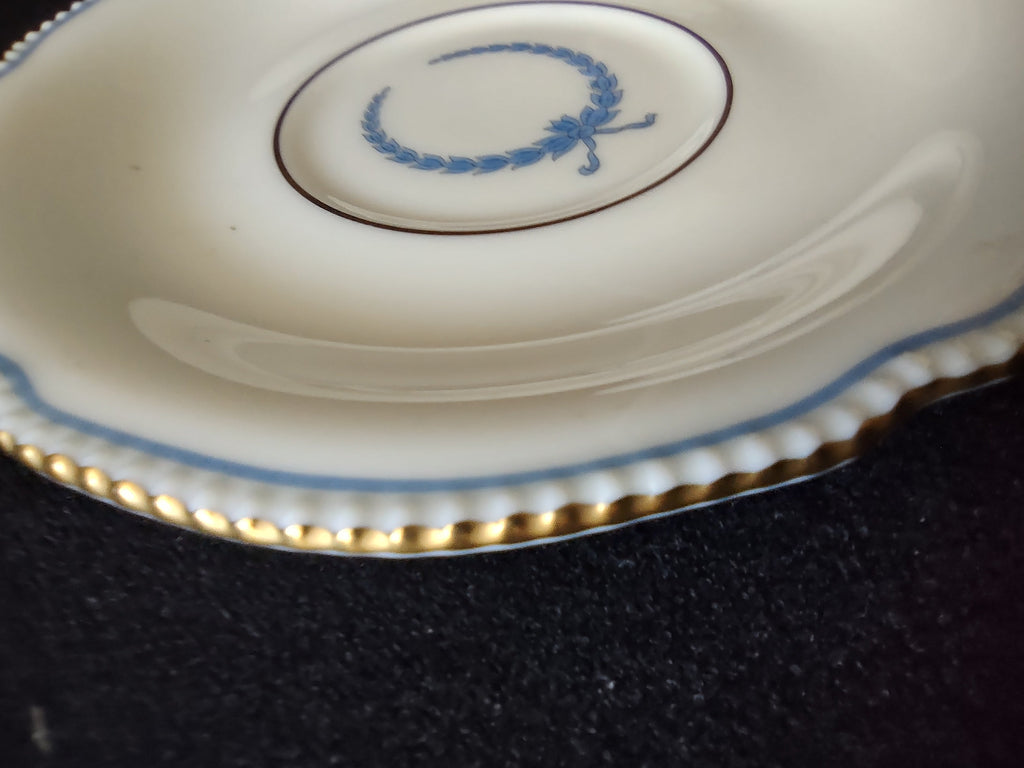 Saucer detail showing blue laurel wreath center and beaded scalloped edge