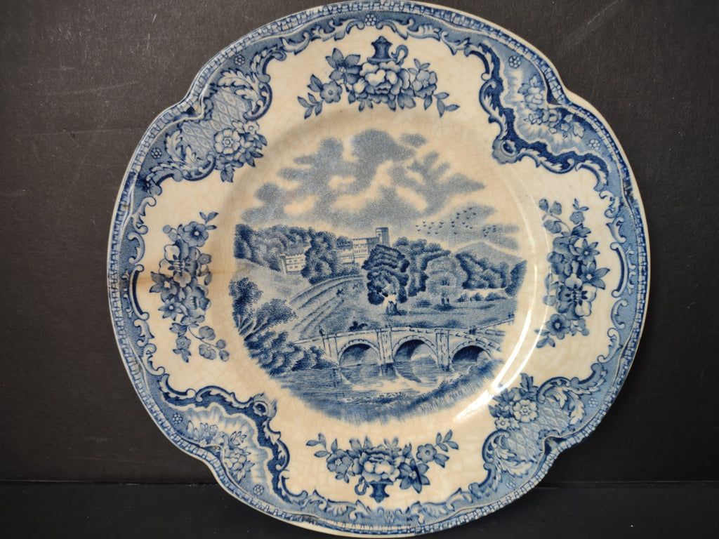 Johnson Bros Old Britain Castles blue transferware plate front view on dark background