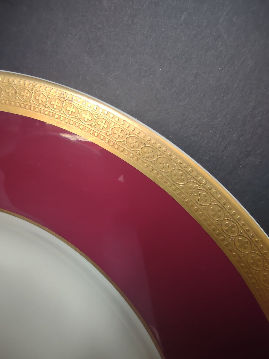 Close-up of crimson band and embossed gold filigree border on Syracuse China plate