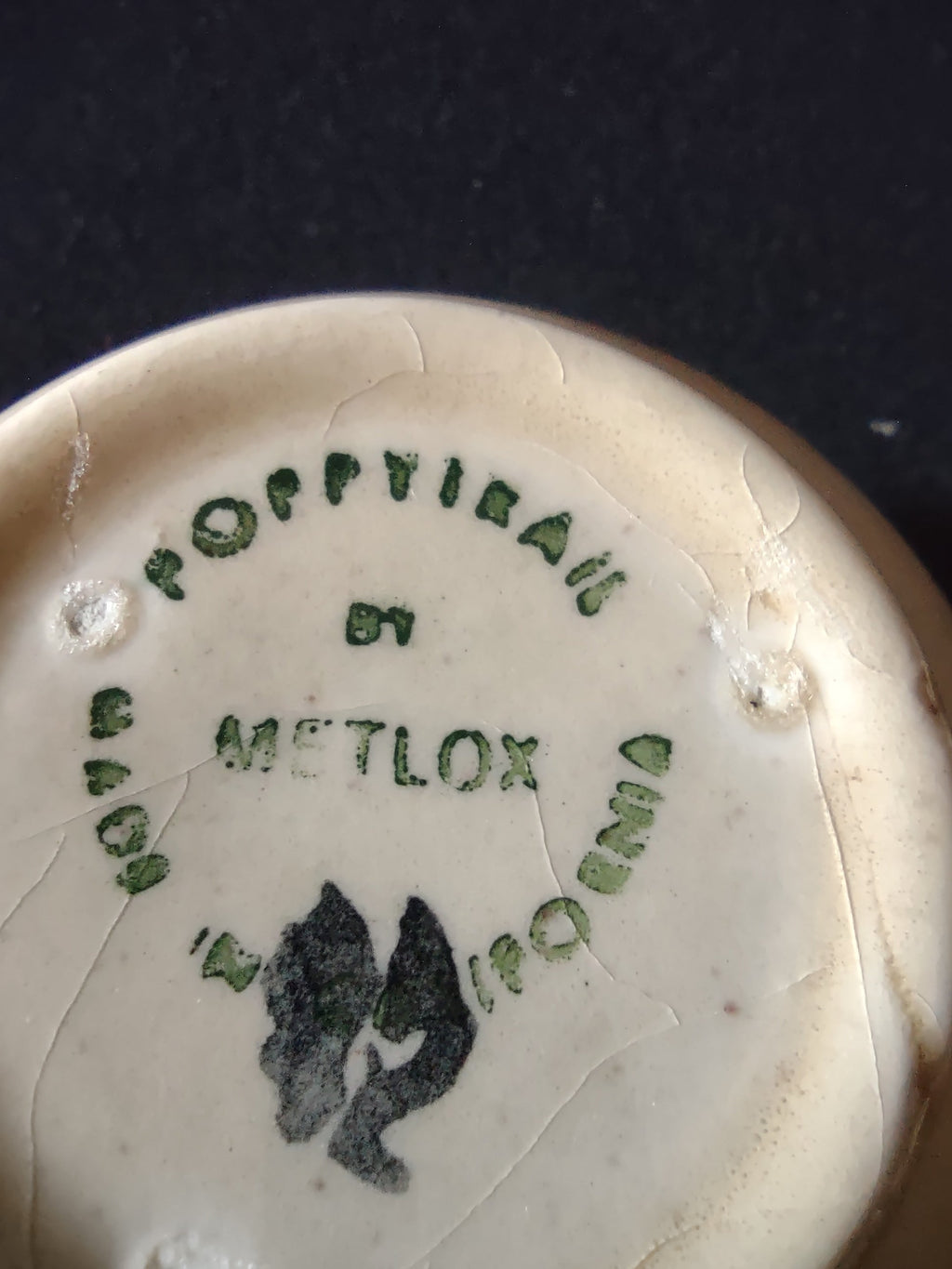 Close-up of Metlox Poppytrail backstamp showing crazing on base of Navajo cup