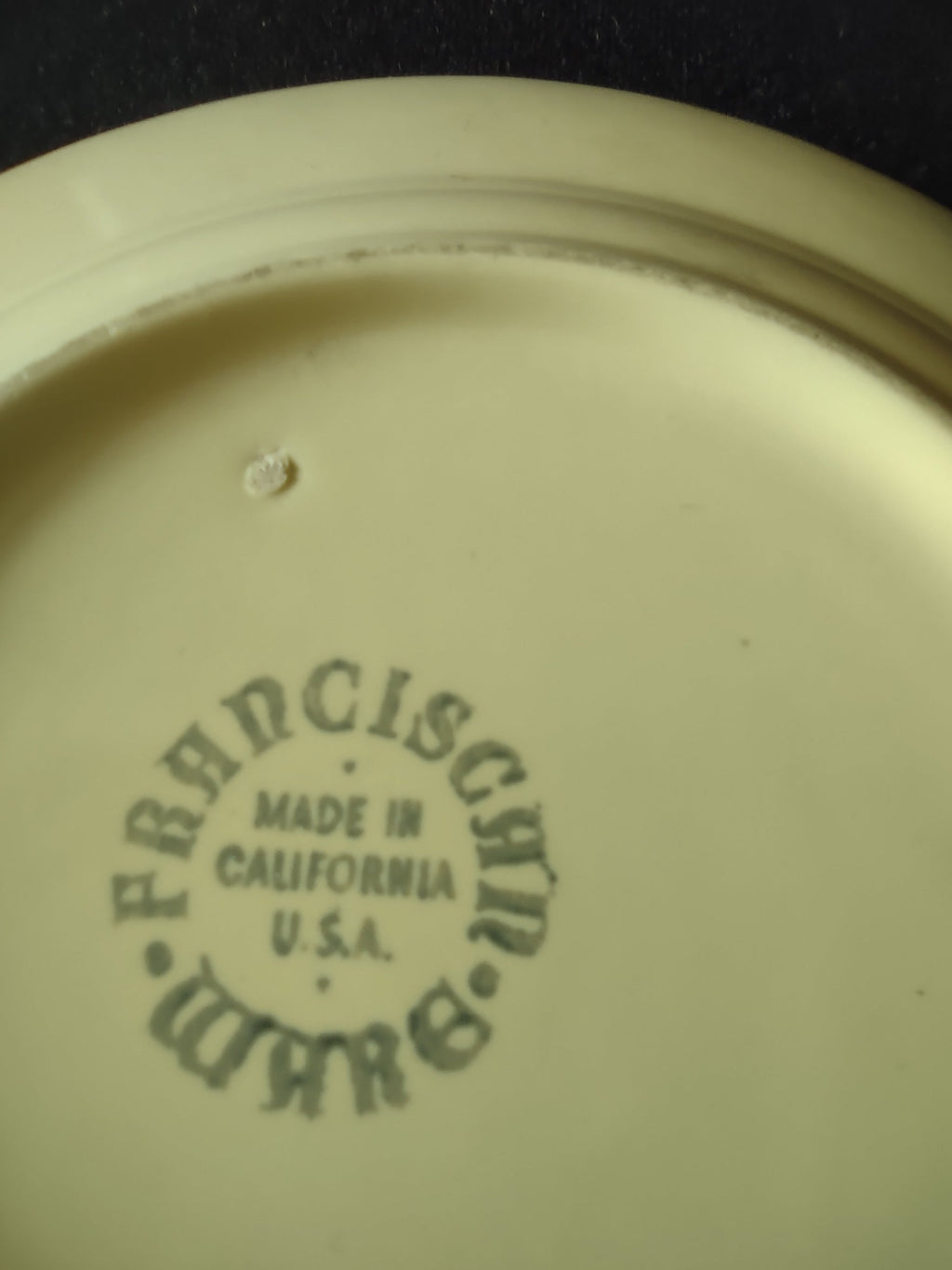 Vintage Franciscan Ware Swirl yellow plate with ruler showing approximately 6.5 inch diameter