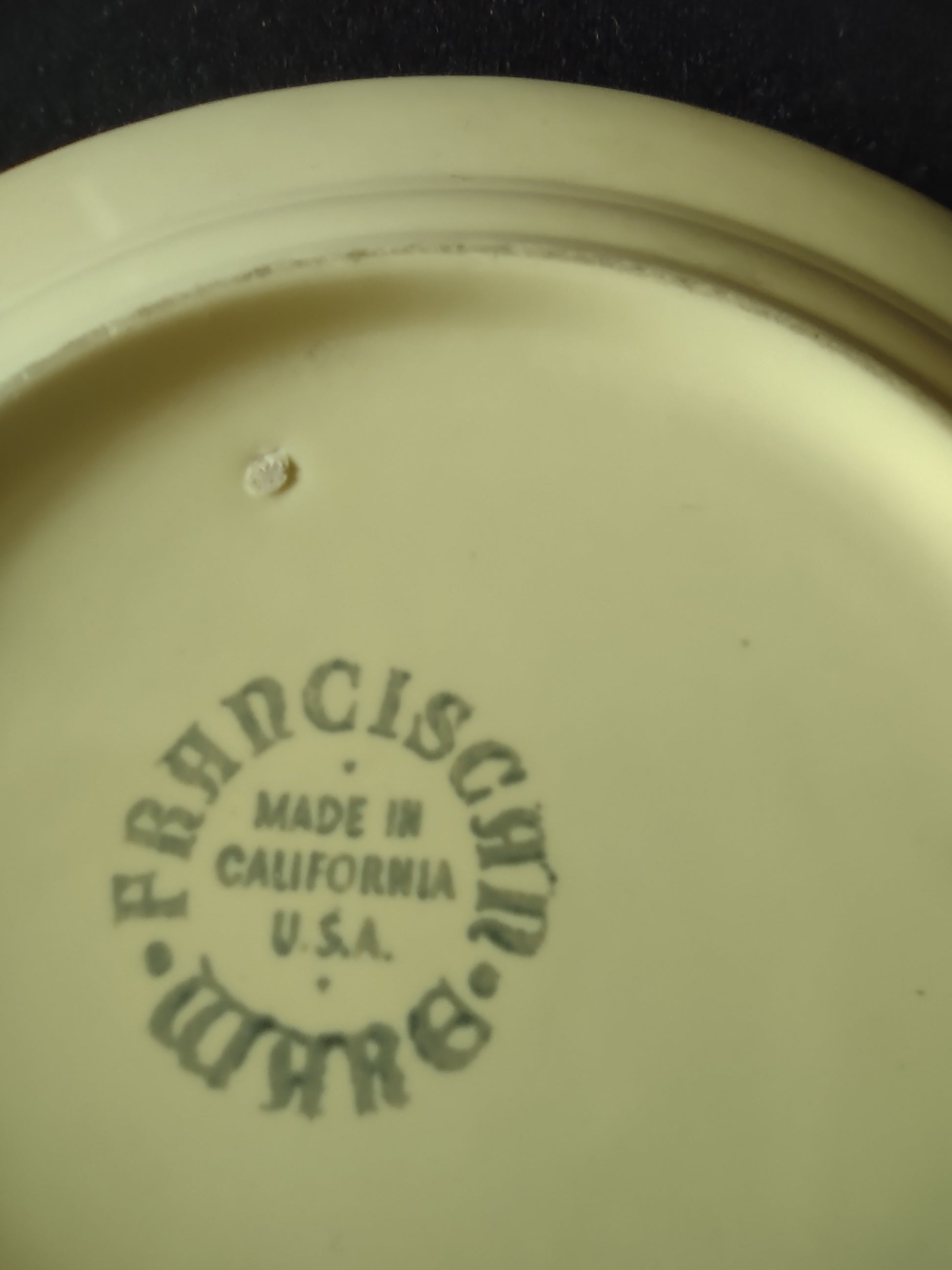 Vintage Franciscan Ware Swirl yellow plate with ruler showing approximately 6.5 inch diameter