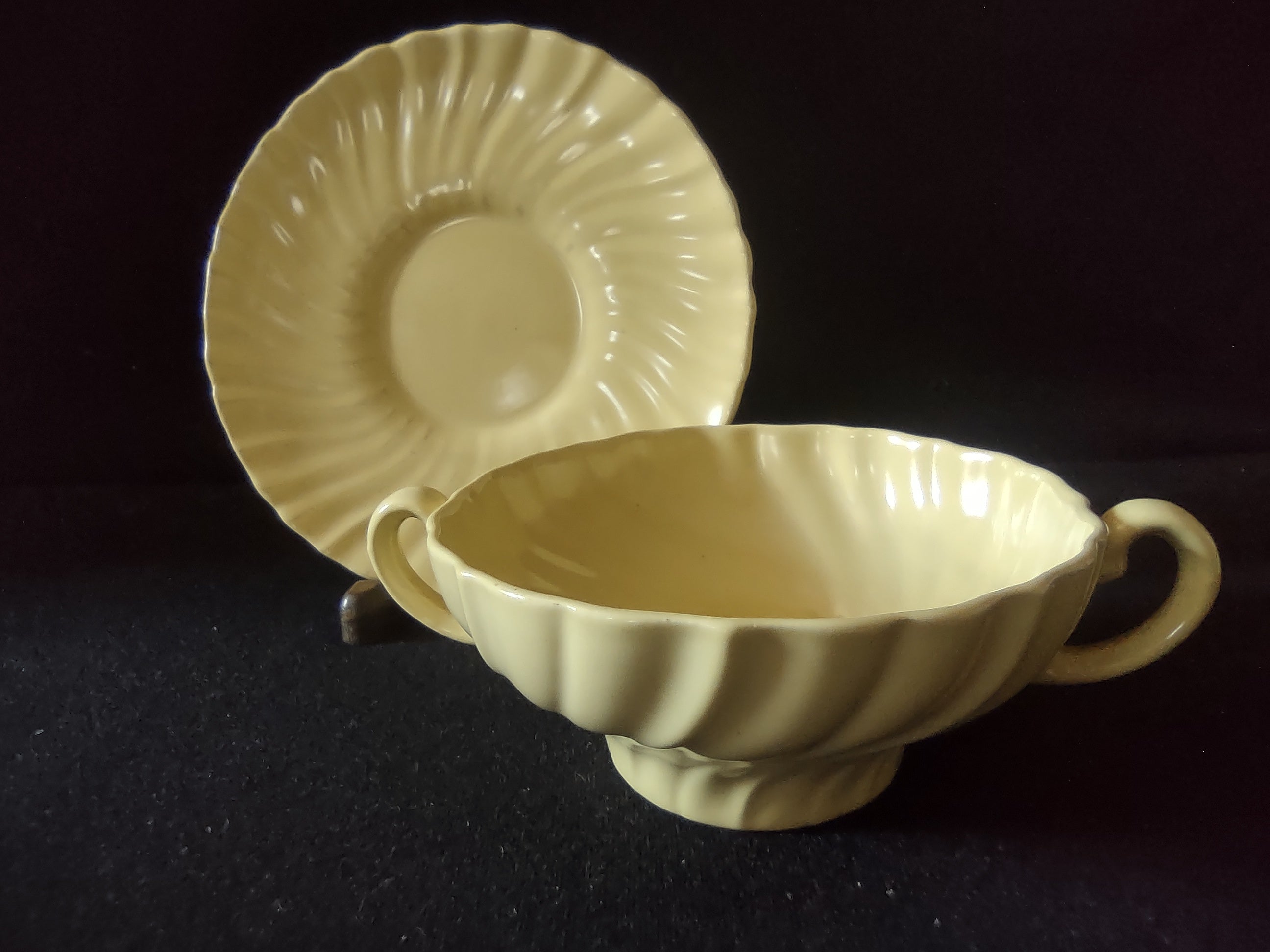 Franciscan Ware Swirl yellow saucer with ruler showing approximately 6 inch diameter