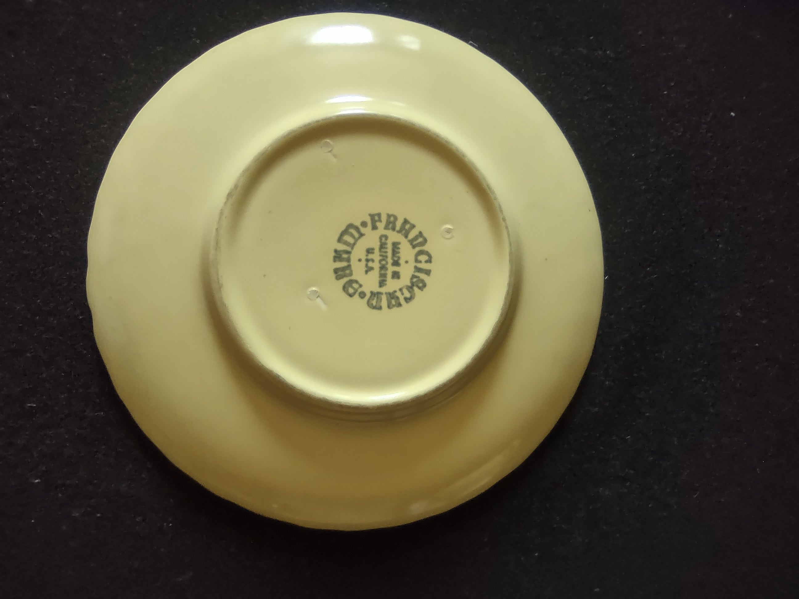 Close-up of SCRATCH on exterior of Franciscan Ware Swirl yellow cream soup bowl