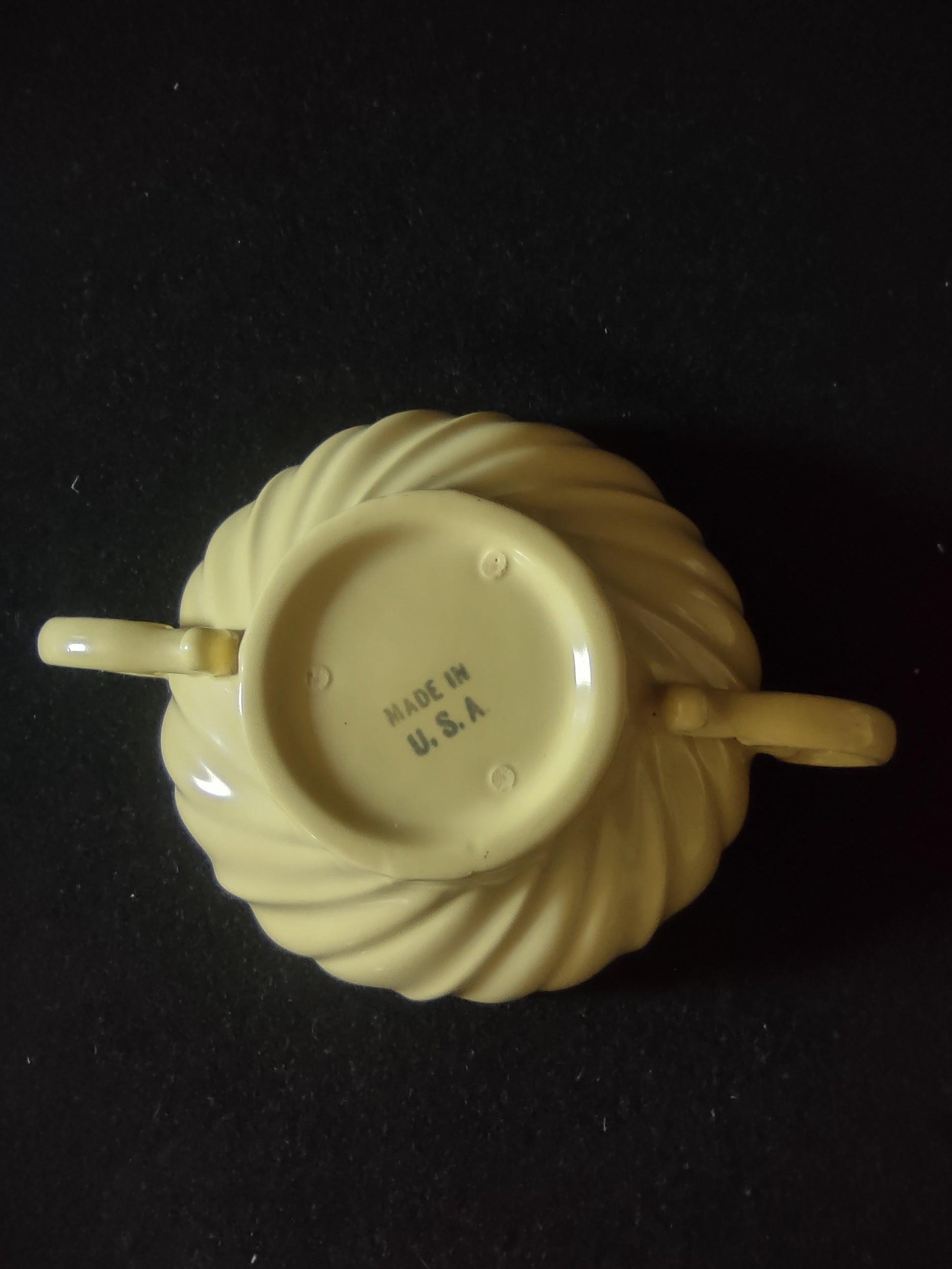 Close-up detail of Franciscan Ware Swirl yellow saucer fluted rim