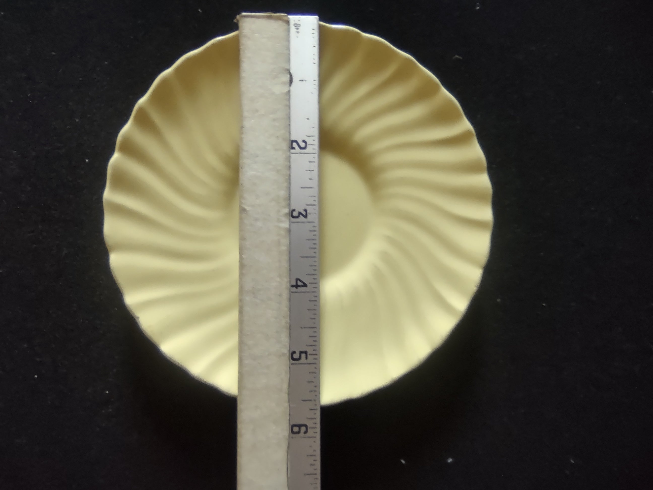Vintage Franciscan Ware Swirl Cream Saucer - front view on stand showing swirl ribbing