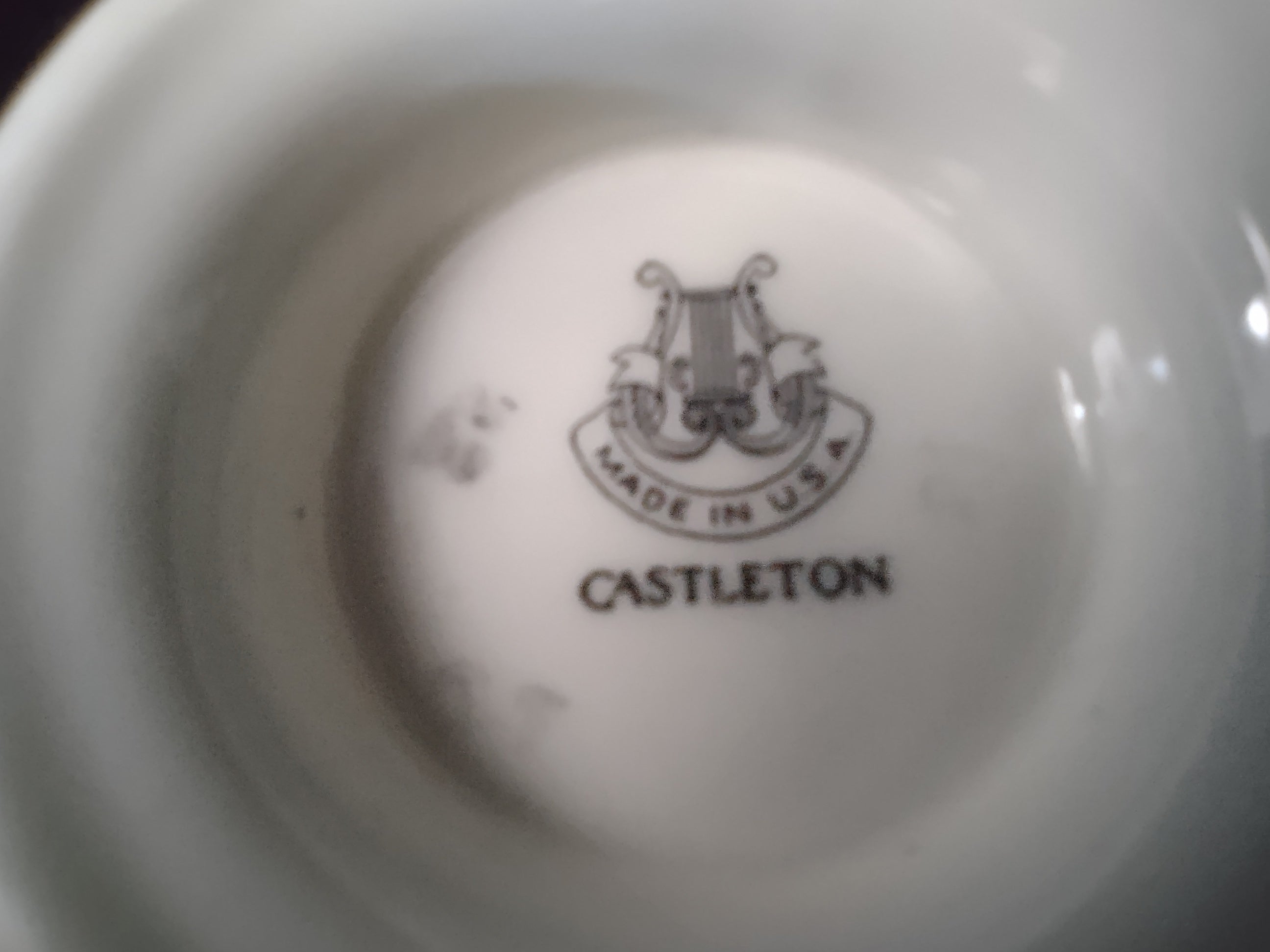 Castleton China Sunnyvale footed teacup showing white floral spray and pink flower motif on celadon ground