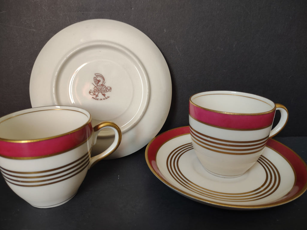 Two Warwick China crimson red gold demitasse cup and saucer sets side by side