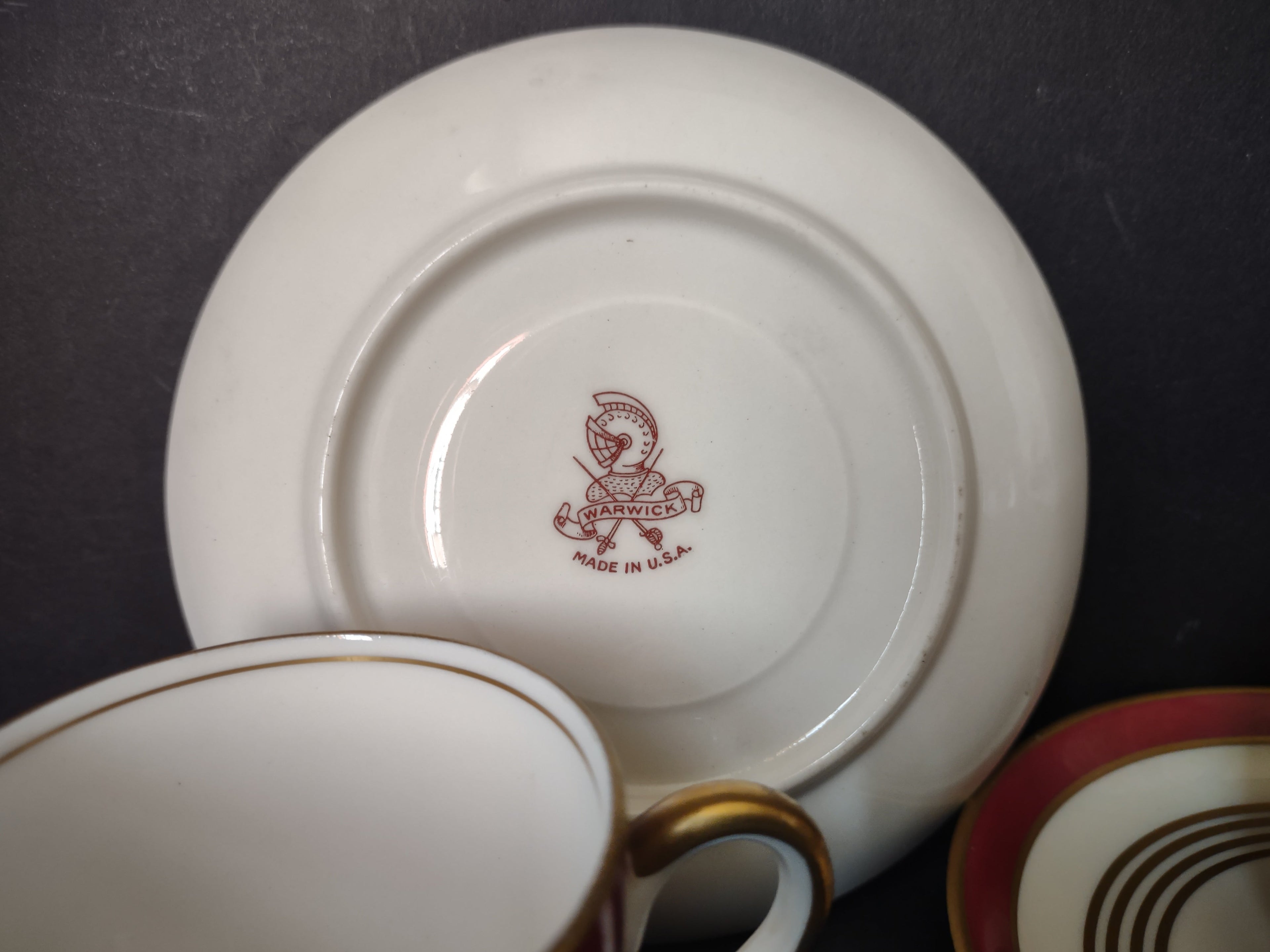 Warwick China demitasse saucer with ruler showing approximately 4.5 inch diameter