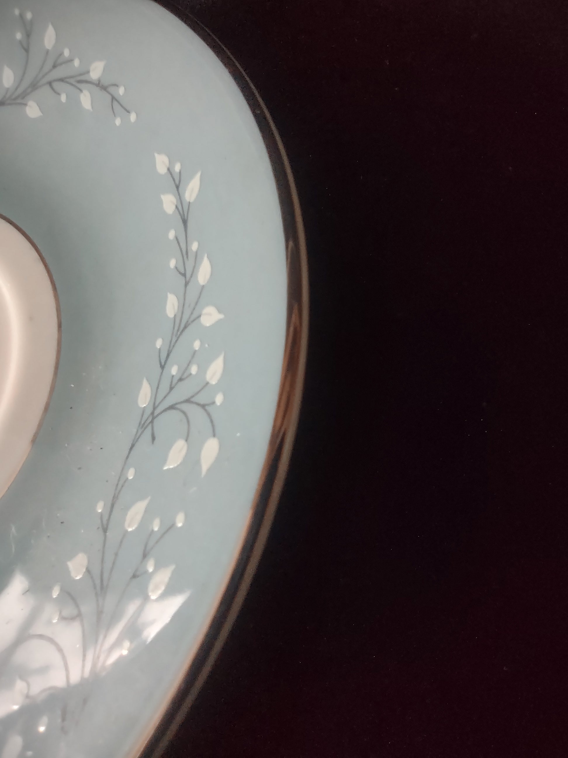 Cup side profile showing leaf sprigs and platinum handle