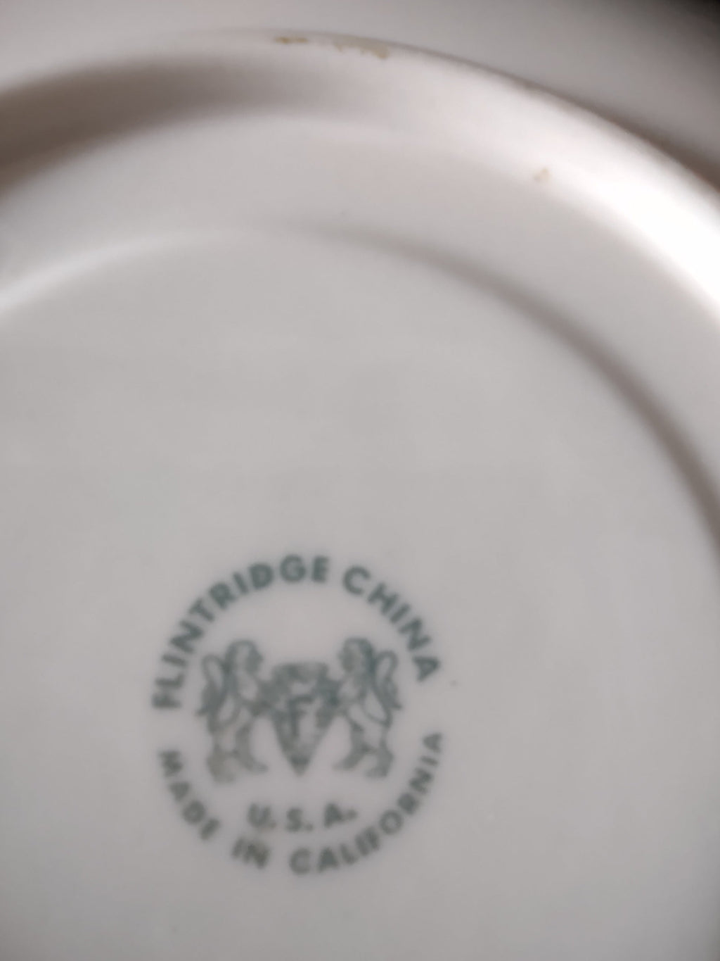Flintridge China saucer with ruler showing approximately 6 inch diameter