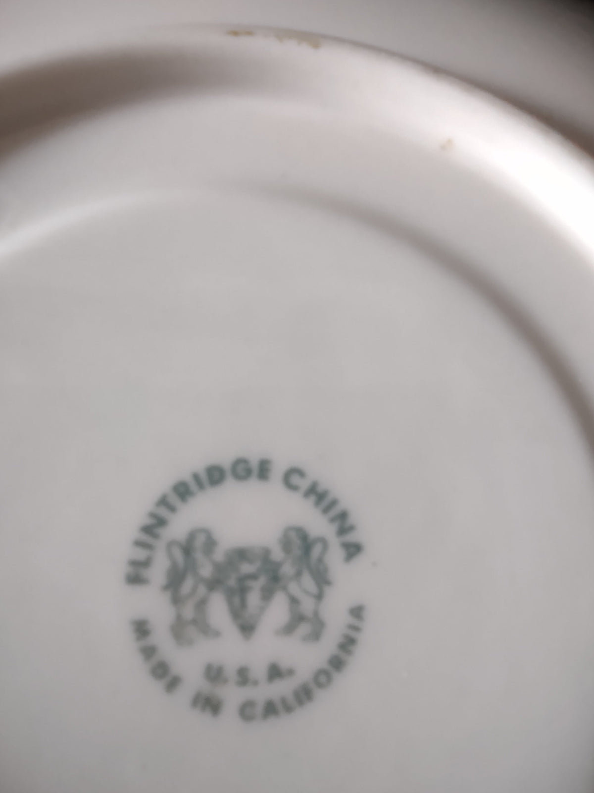 Flintridge China saucer with ruler showing approximately 6 inch diameter