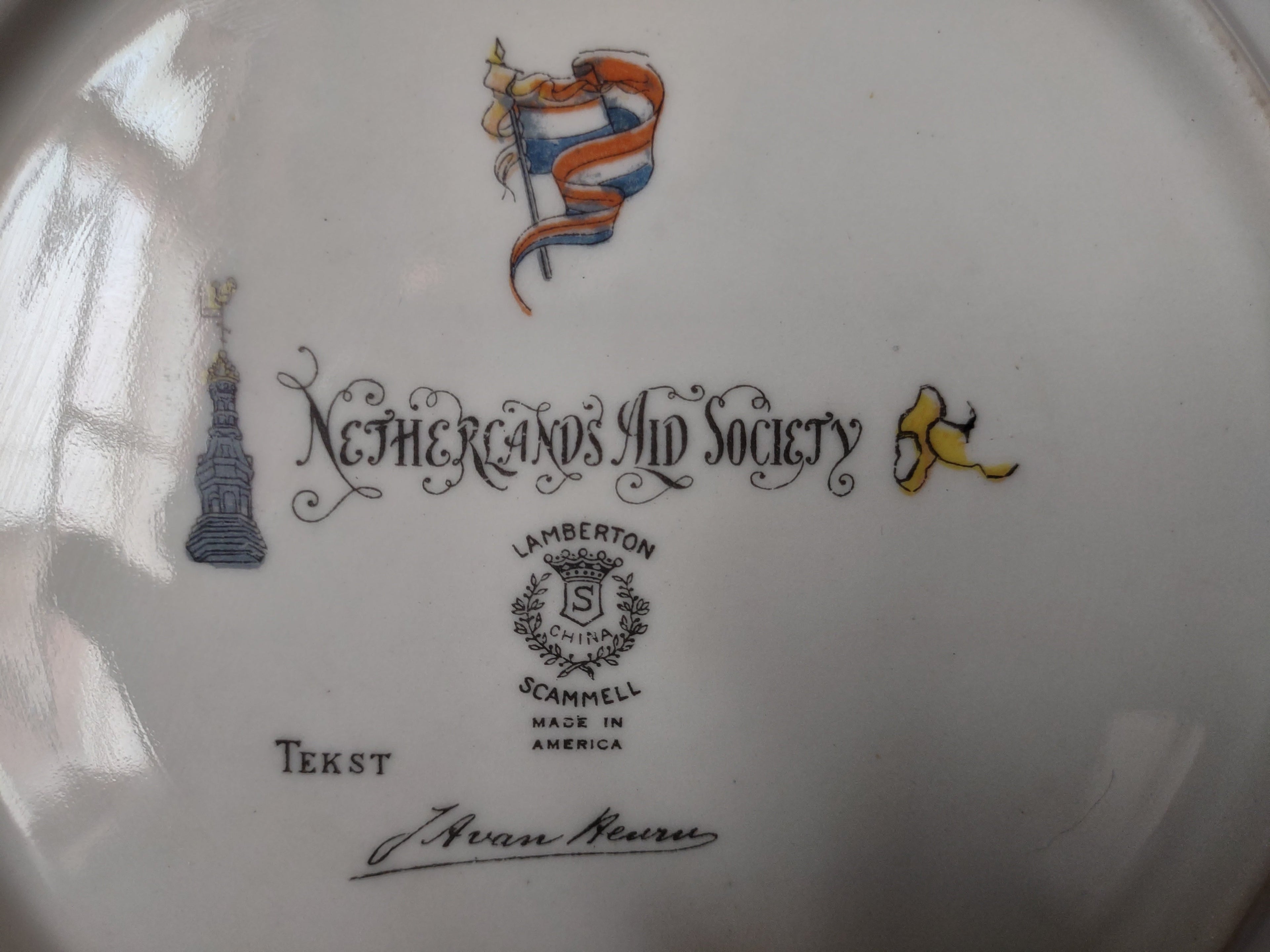 Back of Netherlands Aid Society plate showing full backstamp and off-white rim