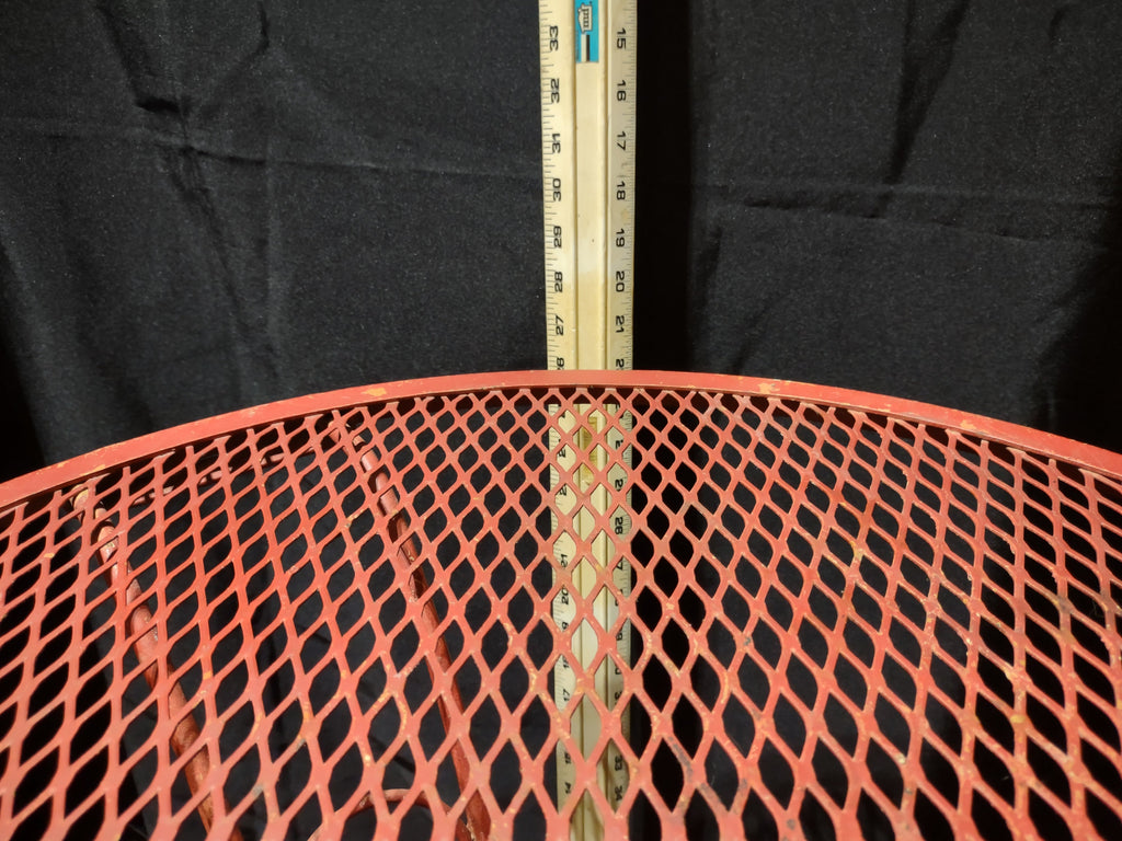 Vintage red metal mesh bistro table - tabletop edge with ruler showing approximately 30 inch diameter