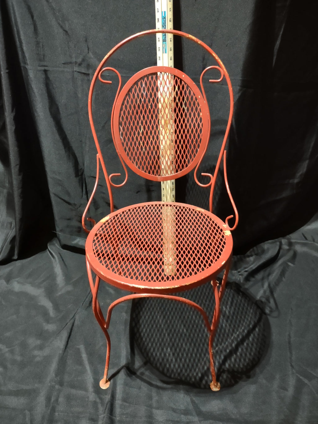 Vintage red metal mesh bistro chair - side angle view showing full profile