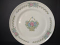 Vintage American Limoges Federal Sampler plate front view showing cross-stitch style flower basket center and zigzag ribbon border with pink and blue floral clusters